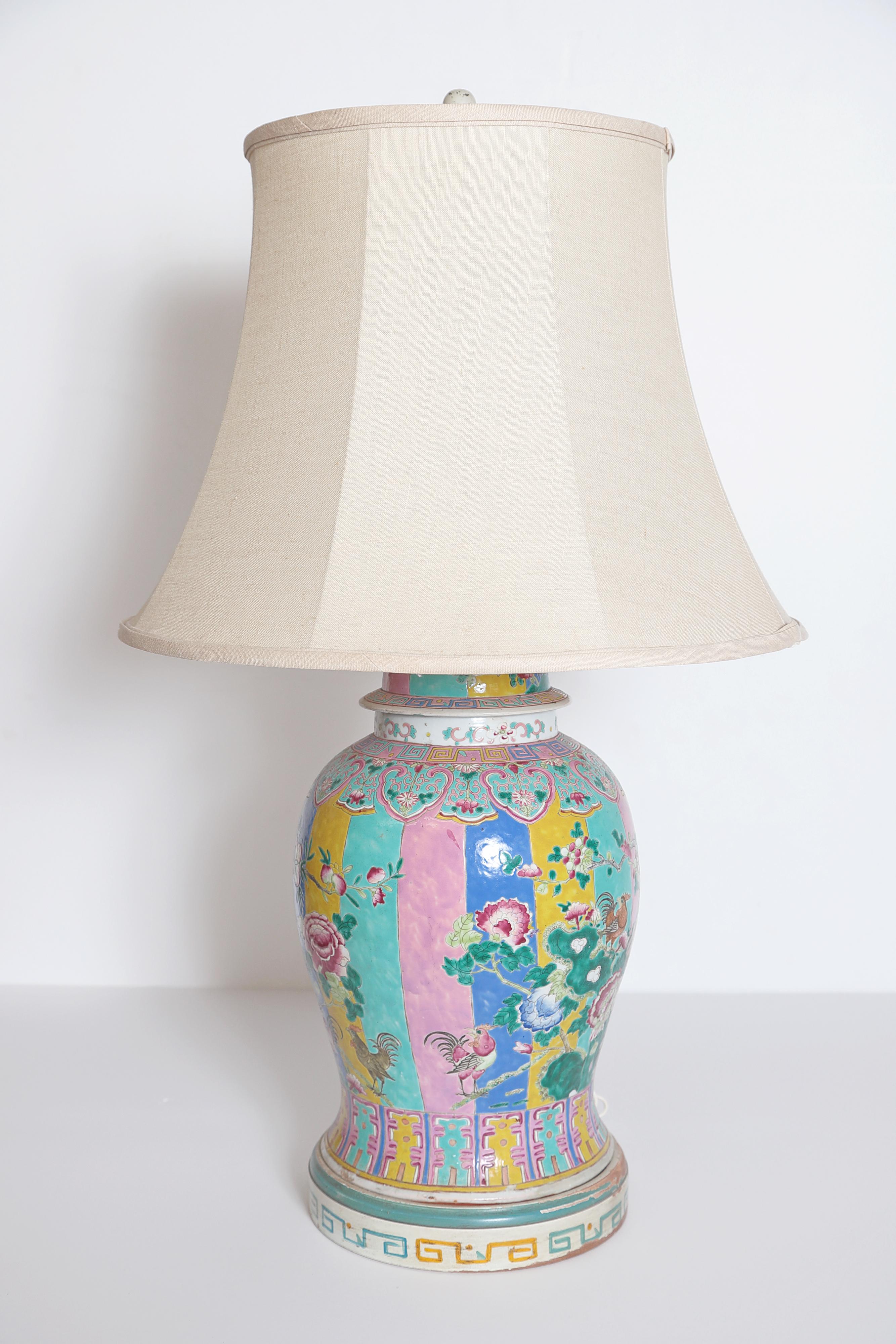 Large Chinese porcelain famille rose ginger jar, drilled as lamp, featuring pastel panels with floral overlay and roosters, custom hand painted base, some losses, chipping and flaking (visible in posted photos), chip to base of ginger jar as well,