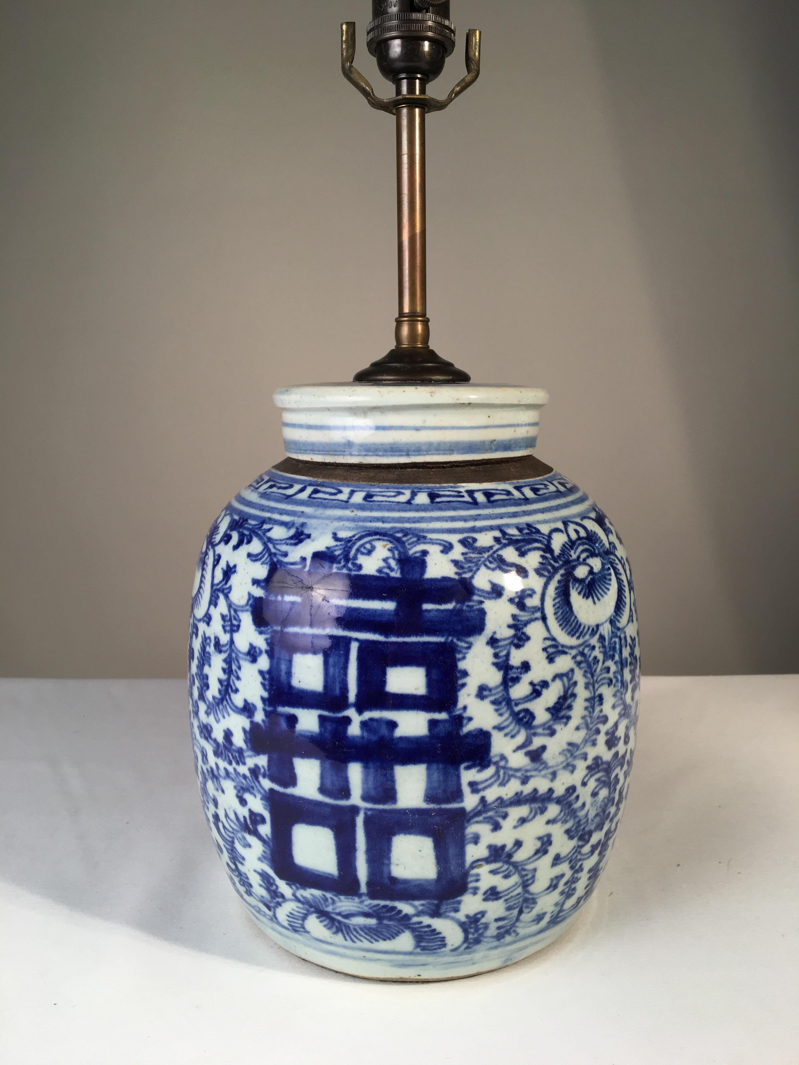 A Chinese blue and white glazed ceramic ginger jar with lid mounted as a lamp. Rewired.