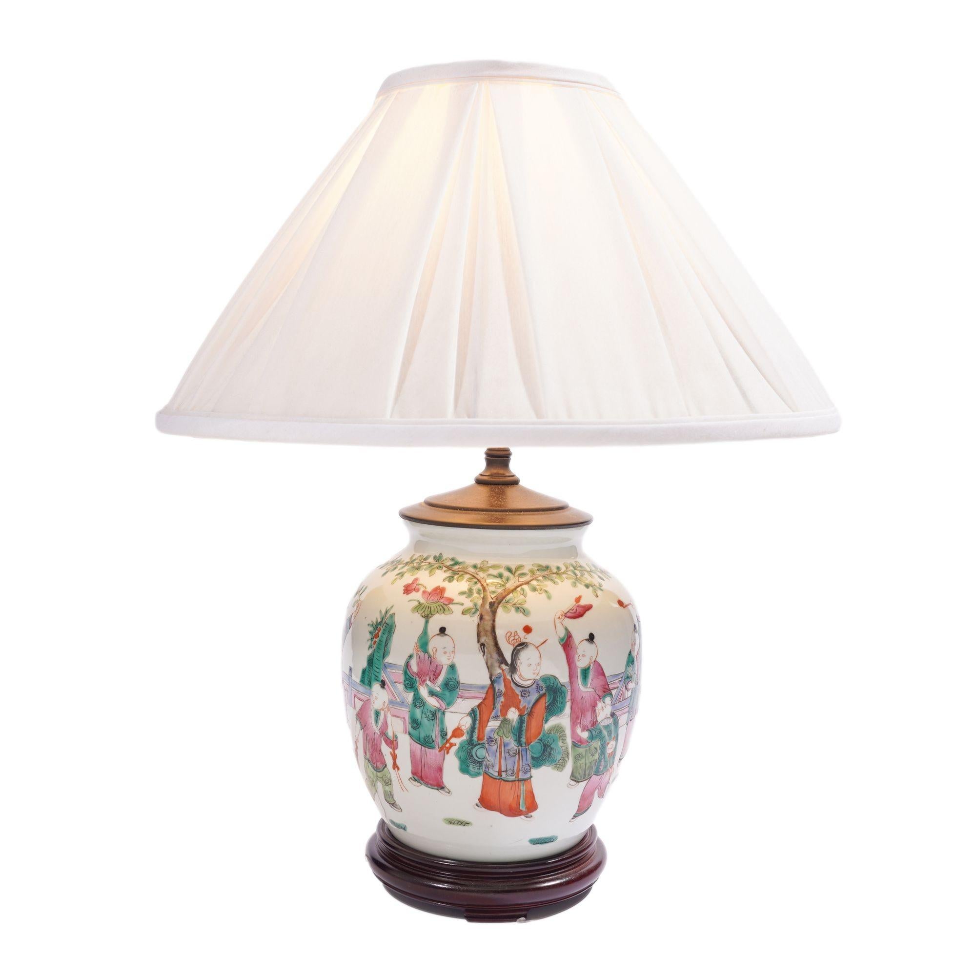 Chinese Qianjiang cai porcelain ginger jar decorated in polychrome enamels and electrified for use as a lamp. The decoration is rendered in rose and shades of green which are the colors of the famille rose palette and is painted with figures of