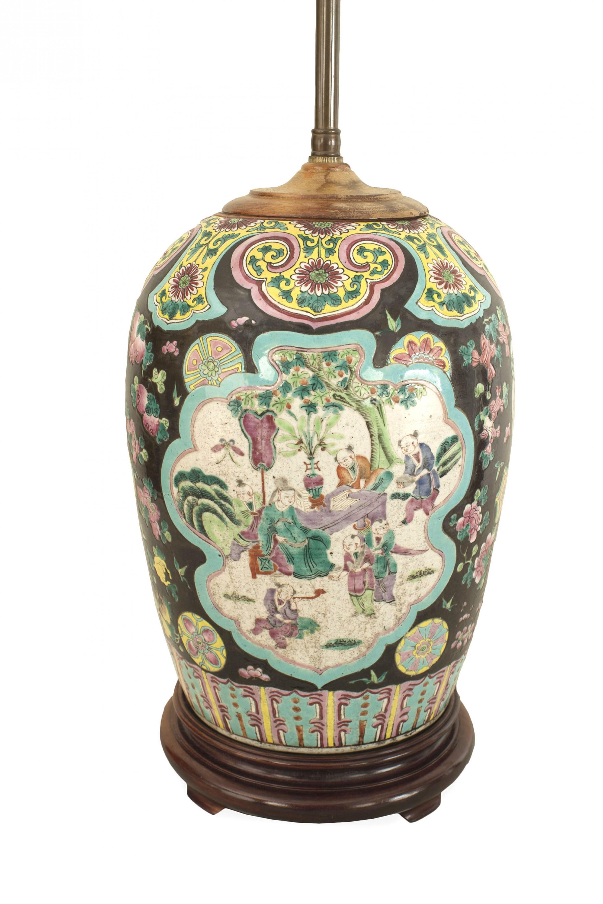 Asian Chinese style (20th Cent) ginger jar shaped table lamp with a black, green & blue background with figures on a wood base.

Ships without a shade