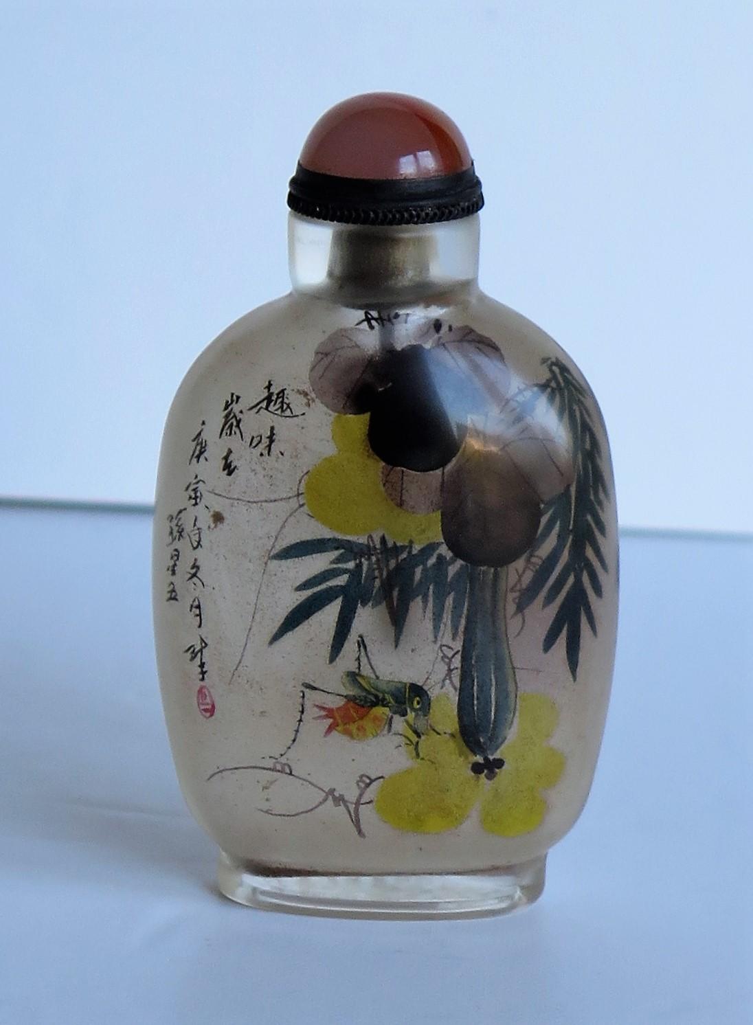This is a very good Chinese glass snuff bottle, which is beautifully inside hand painted and dating to the later half of the 19th century, Qing period, circa 1870

It is made of a very smooth clear glass which has then been very finely hand