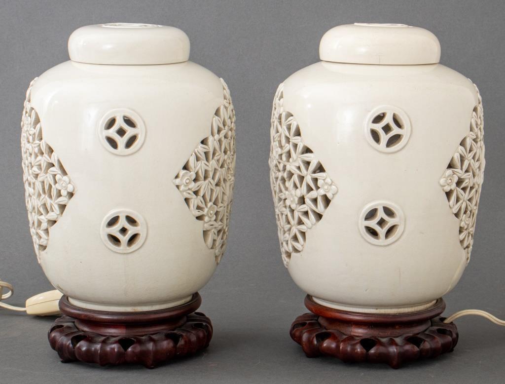 Chinese glazed ceramic pair of reticulated lamps, in the form of covered ginger jars on stands, the sides elaborately pierced. 

Dealer: S138XX