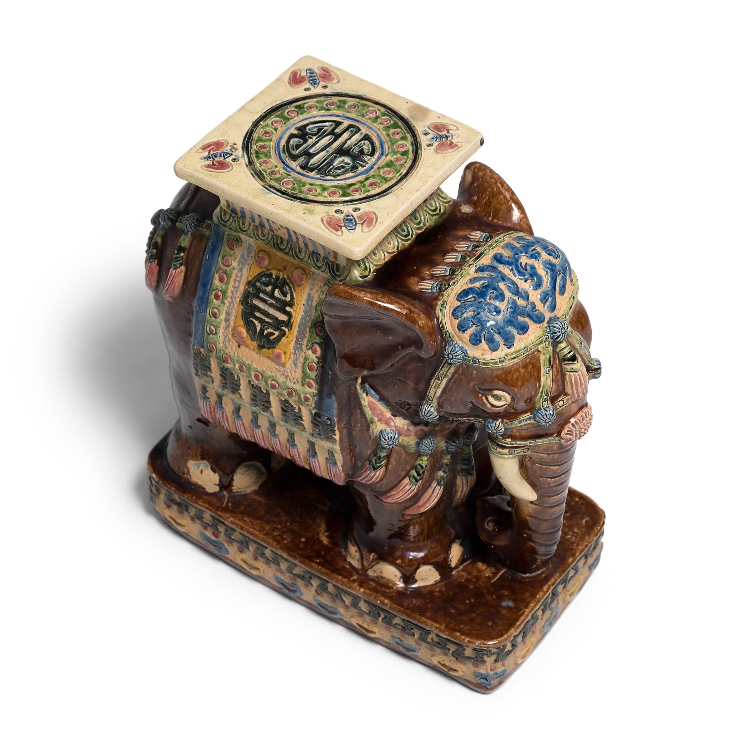 Glazed in a loose, free drip style that recalls ancient sancai ware, this colorful ceramic garden stool charms with a dark brown glaze accented with bold blues, greens, and yellows. Sculpted in the shape of an elephant, the seat blends both form and