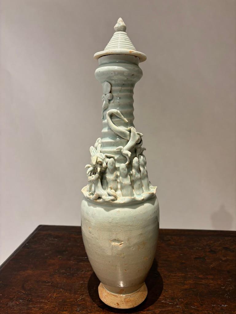 Pair of Chinese Ying Qing  (“shadowy blue”) ware  porcelain vases with ceremonial urns dating from the 12th century, Song dynasty. These two stunning vases depict the 12 traditional ritual attendants around the urns, topped with a dragon and the