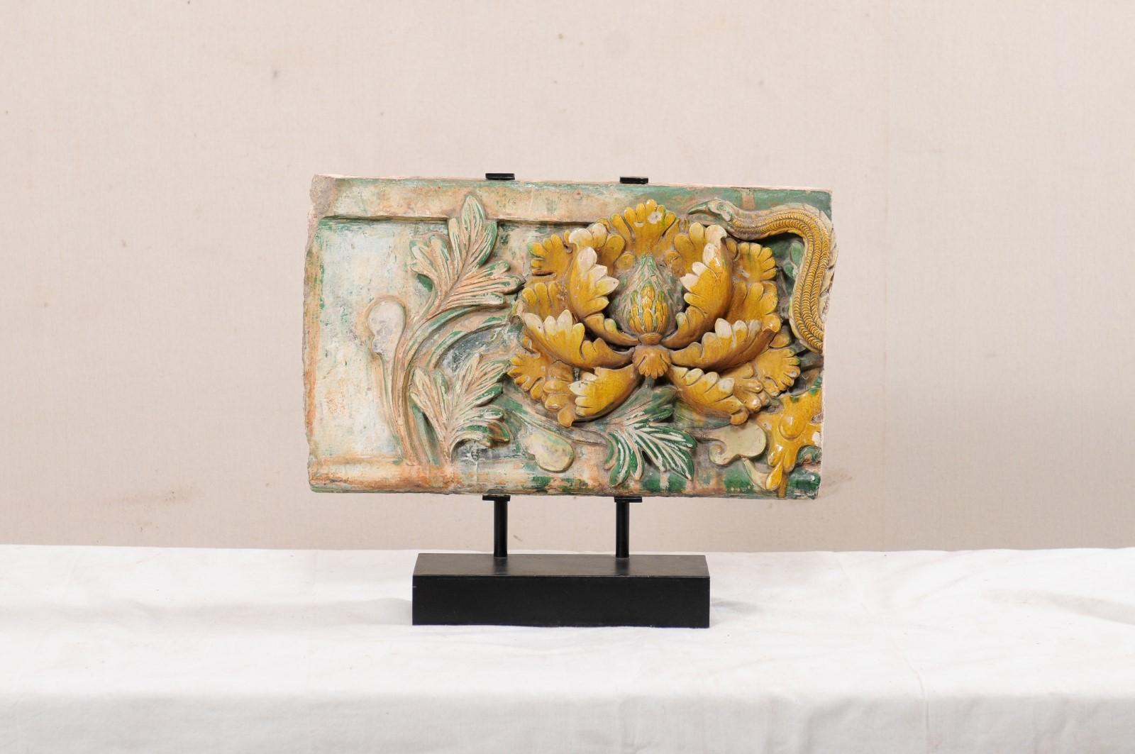 A Chinese glazed terracotta temple fragment from the 19th century (or possibly older). This antique terracotta architectural piece has been created from a cut section of a Chinese temple fragment, which is now presented upon on a custom black iron