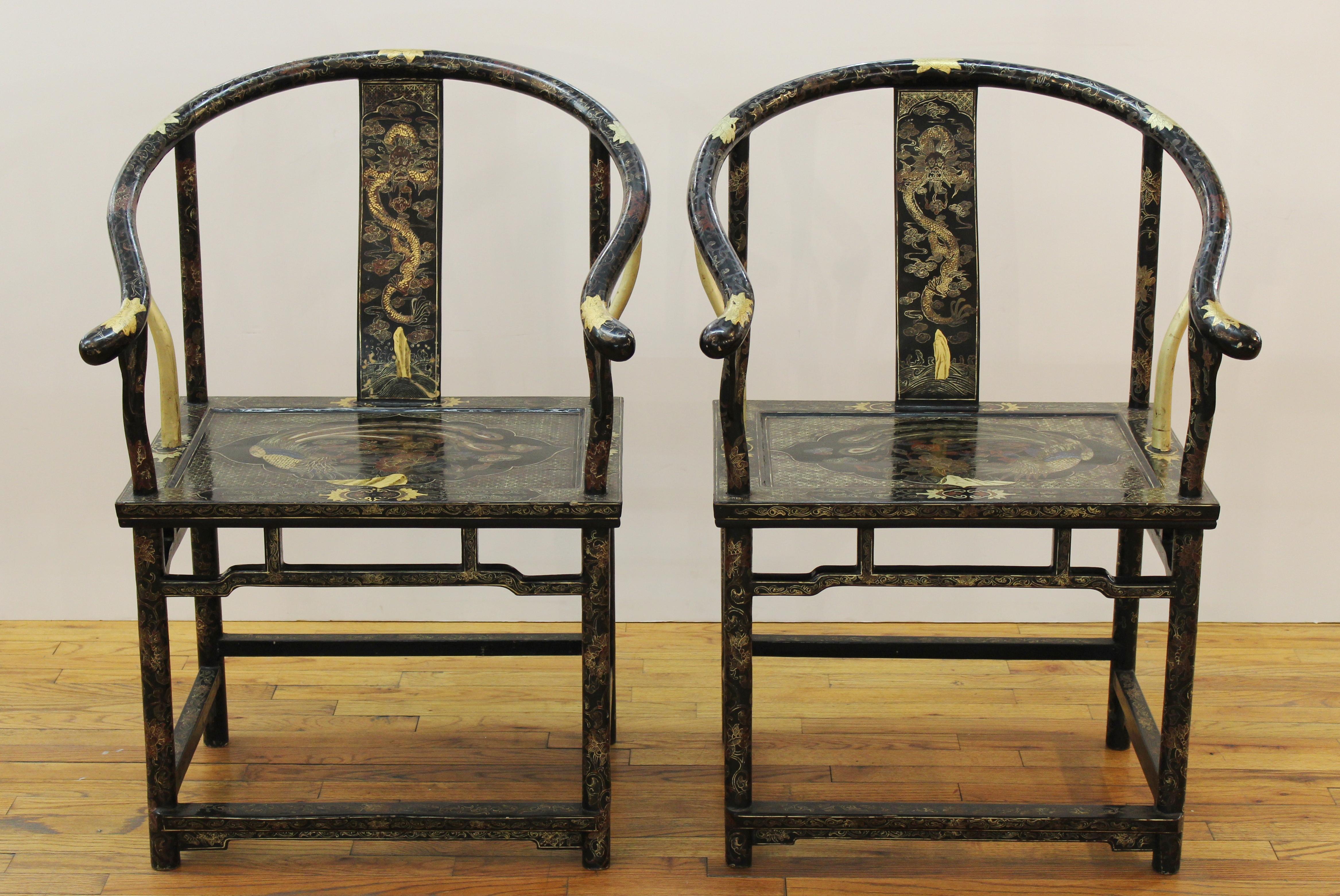 Pair of Chinese horseshoe back armchairs with gold painted decoration of dragons on the backrests and peacocks on the seats