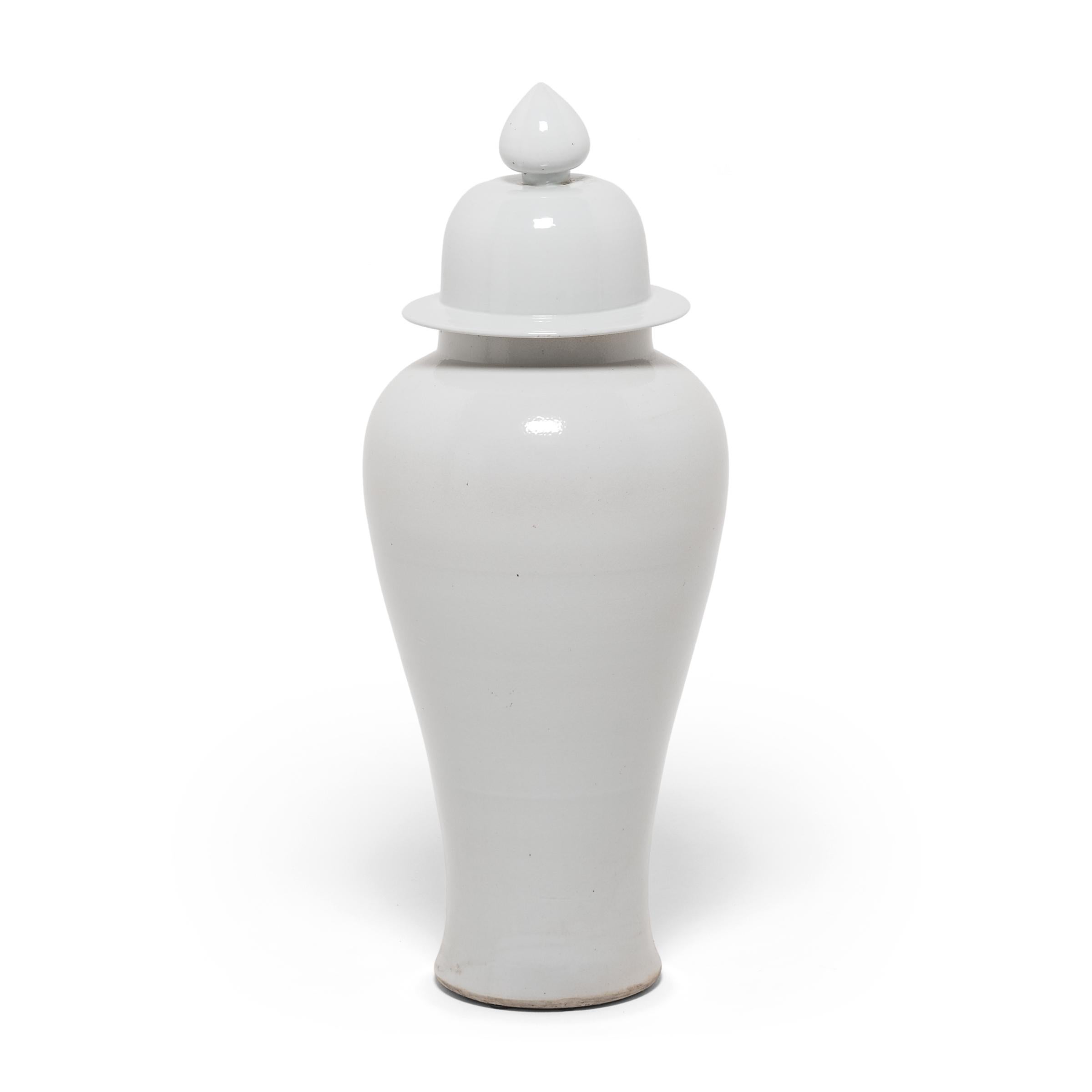 The striking pure creme color of this monumental lidded ceramic vase draws on a long Chinese tradition developed during the Song dynasty, when artisans began to develop the art of monochrome glazes in a single, statement-making color.

Additional