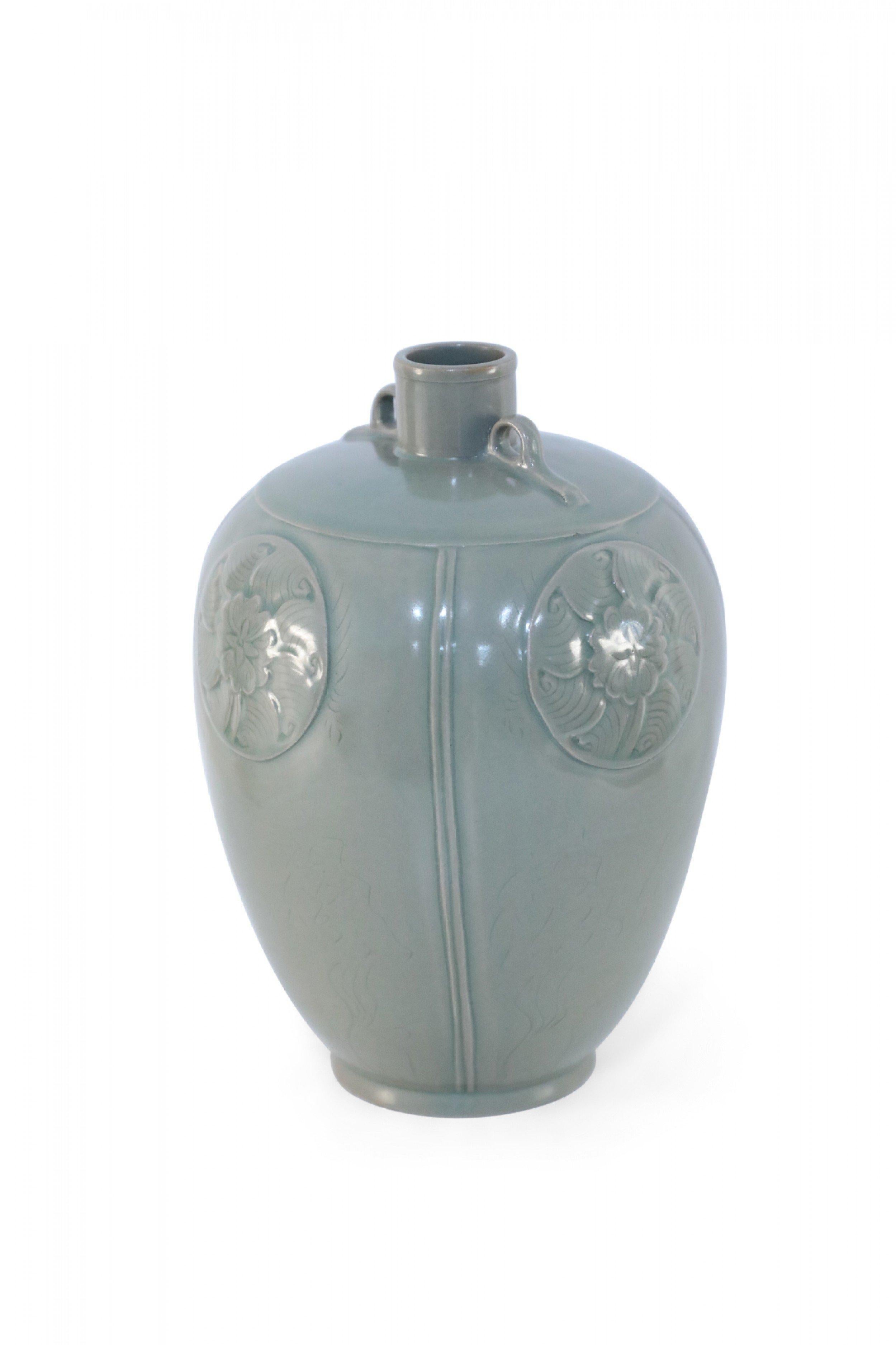 Antique Chinese (Late 19th century) gray porcelain vase in a Meiping form carved with tonal floral medallions and accented with diminutive handles at the opening.
    