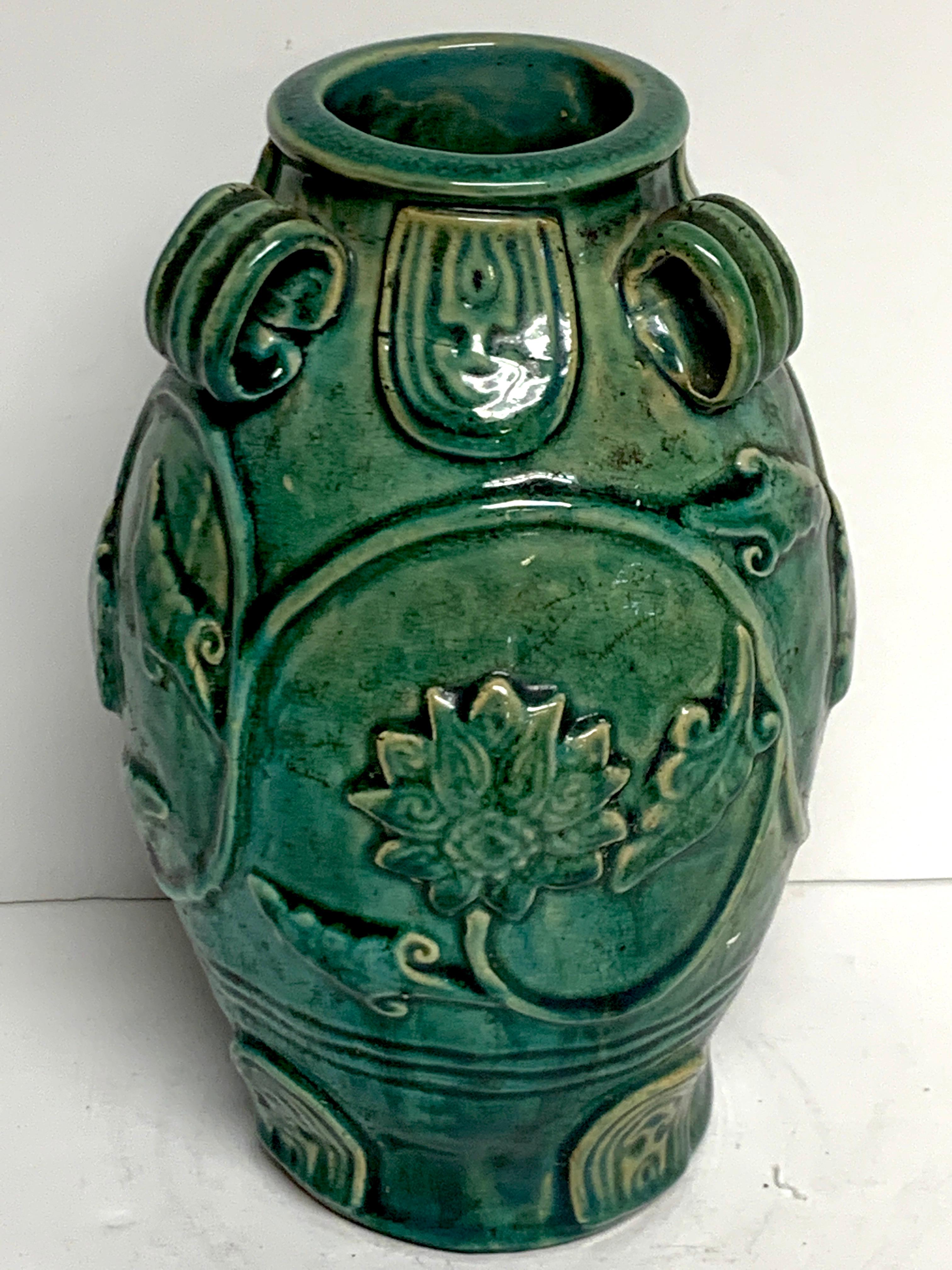 Chinese green glazed lotus motif vase, with three handles.
