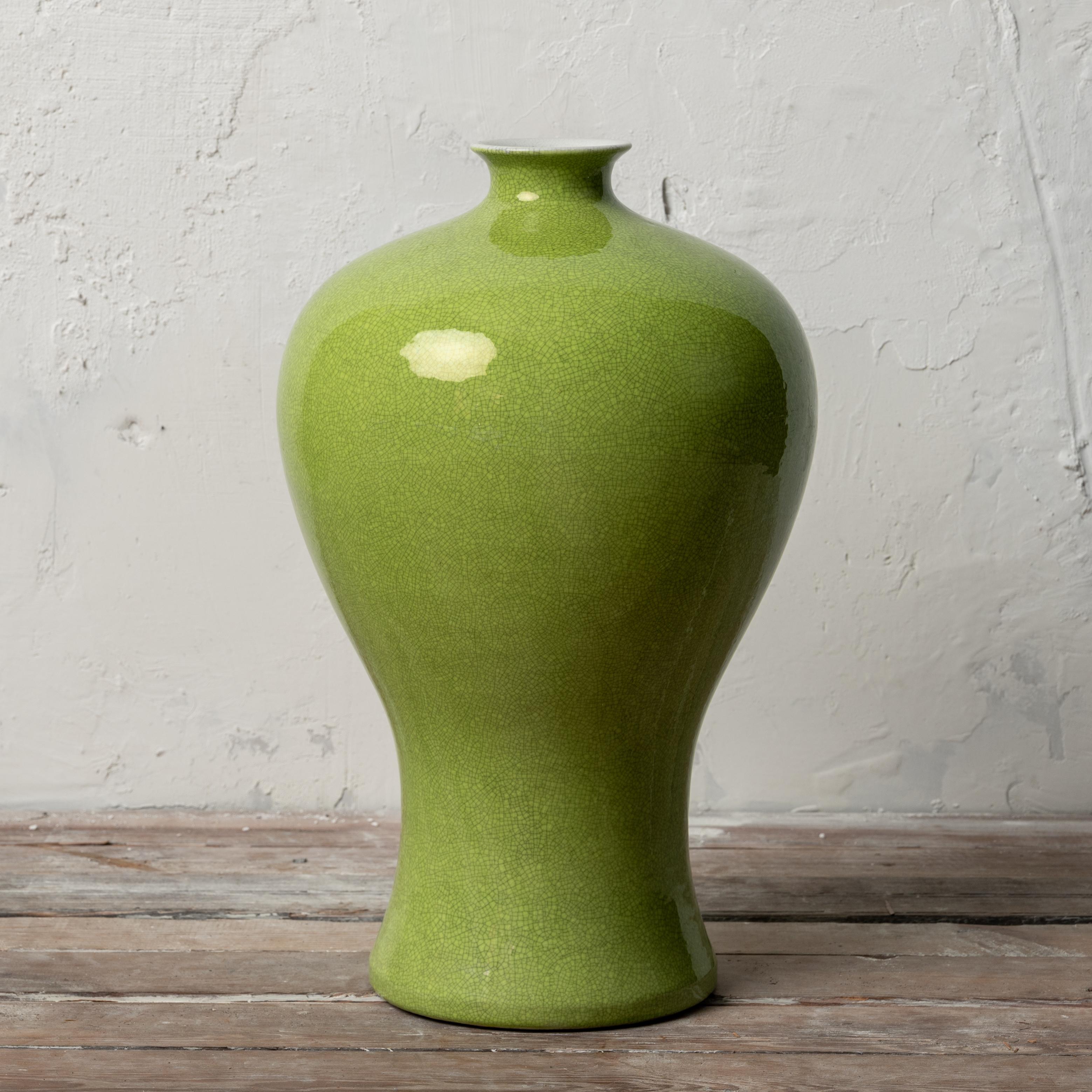 A Chinese monochrome porcelain meiping vase in crackled lime-green glaze with apocryphal Chenghua mark.

10 ½ inches wide by 17 inches tall

