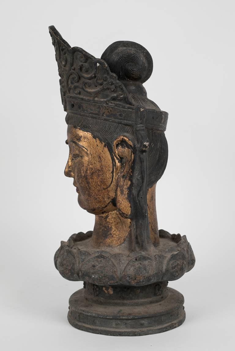 A Chinese polychrome bronze depiction of Guanyin the Goddess of compassion and mercy. What makes this presentation more unique is the fact that Gaunyin is on a lotus flower base: the icon for purity and peace.