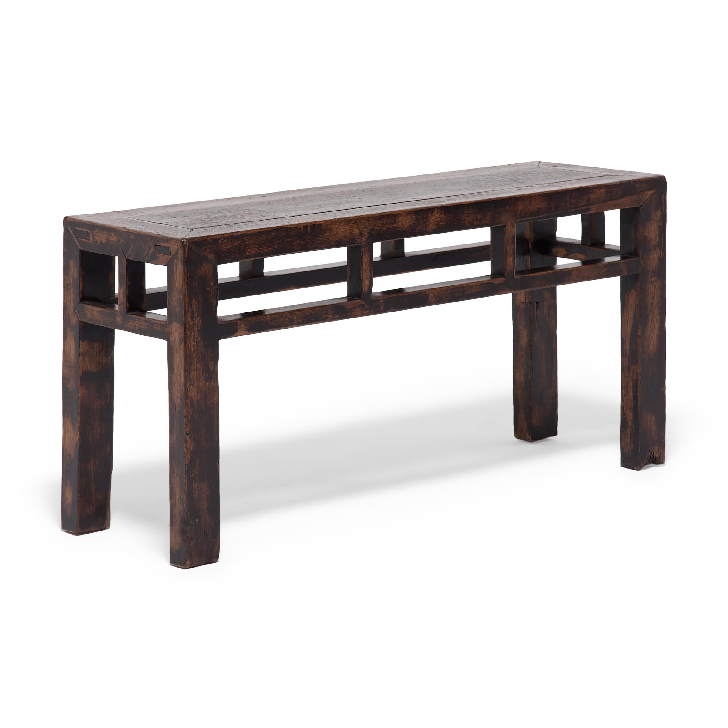 This square corner half bench from China's Shandong province has a straightforward design with clean lines and balanced proportions. Dated to the early 20th century, the bench was constructed of northern elm (yumu) with mortise-and-tenon joinery and