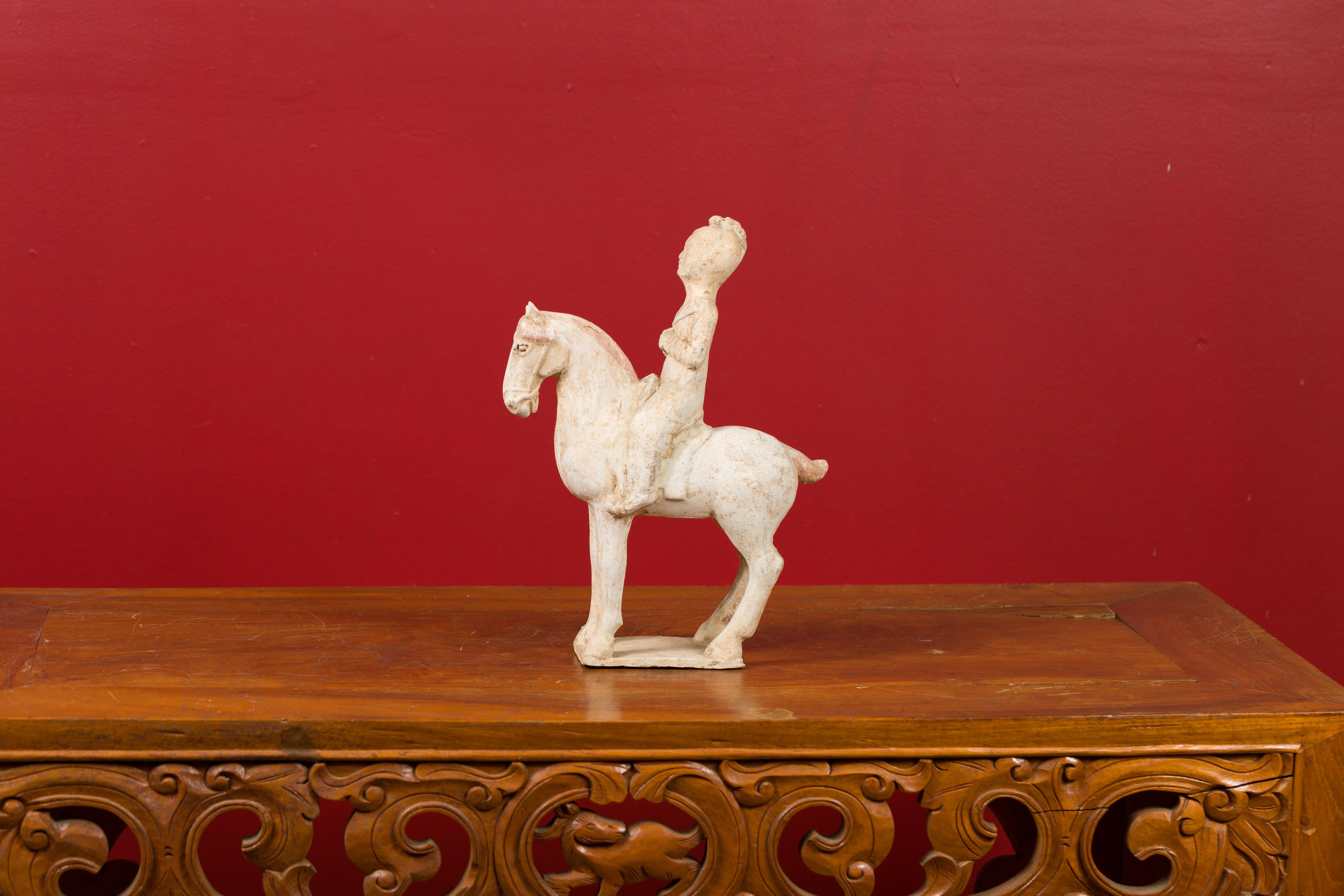 A Chinese Han Dynasty period painted terracotta statuette of a horse and rider, circa 202 BC-200 AD. Created in China during the prestigious Han Dynasty, this statuette, depicting a horse and his rider, showcases remnants of its original polychromy.