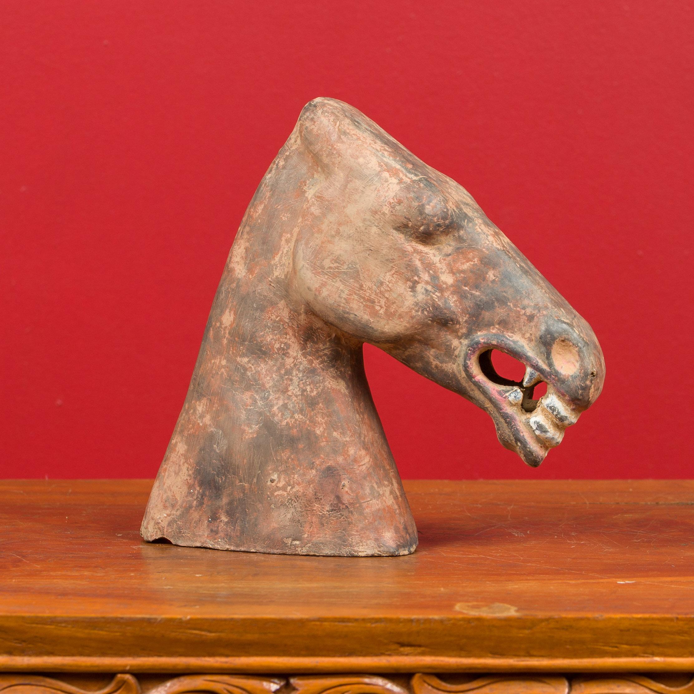 A Chinese Han Dynasty terracotta horse head sculpture circa 202 BC-200 AD, with original pigment. Created in China during the prestigious Han Dynasty, this terracotta sculpture features a horse head boasting a nicely weathered patina and a striking