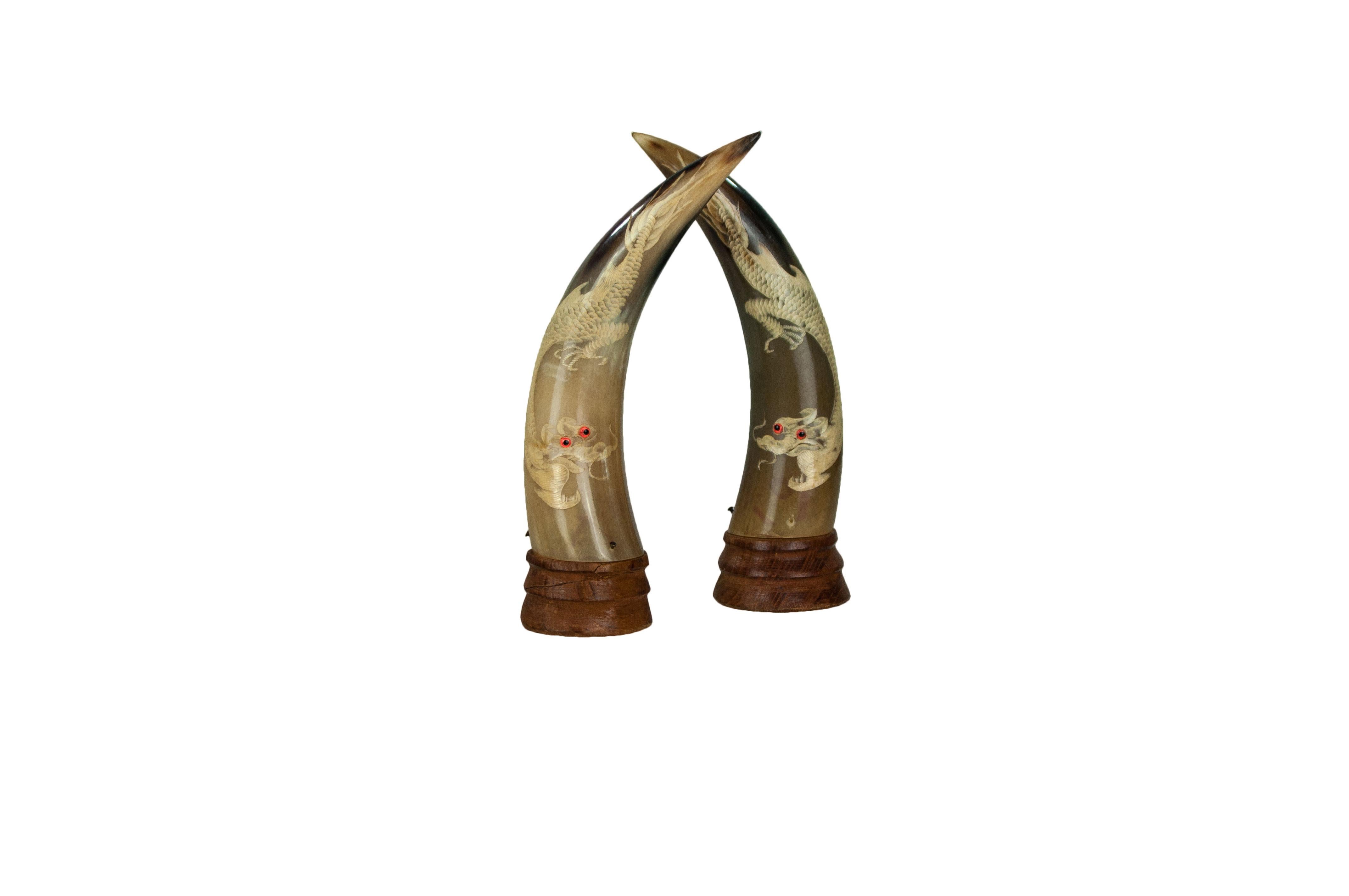 Pair of hand carved horn with white dragon and red glass eyes, circa 1930s. High quality carving work on dragon makes this piece a one of kind to have.