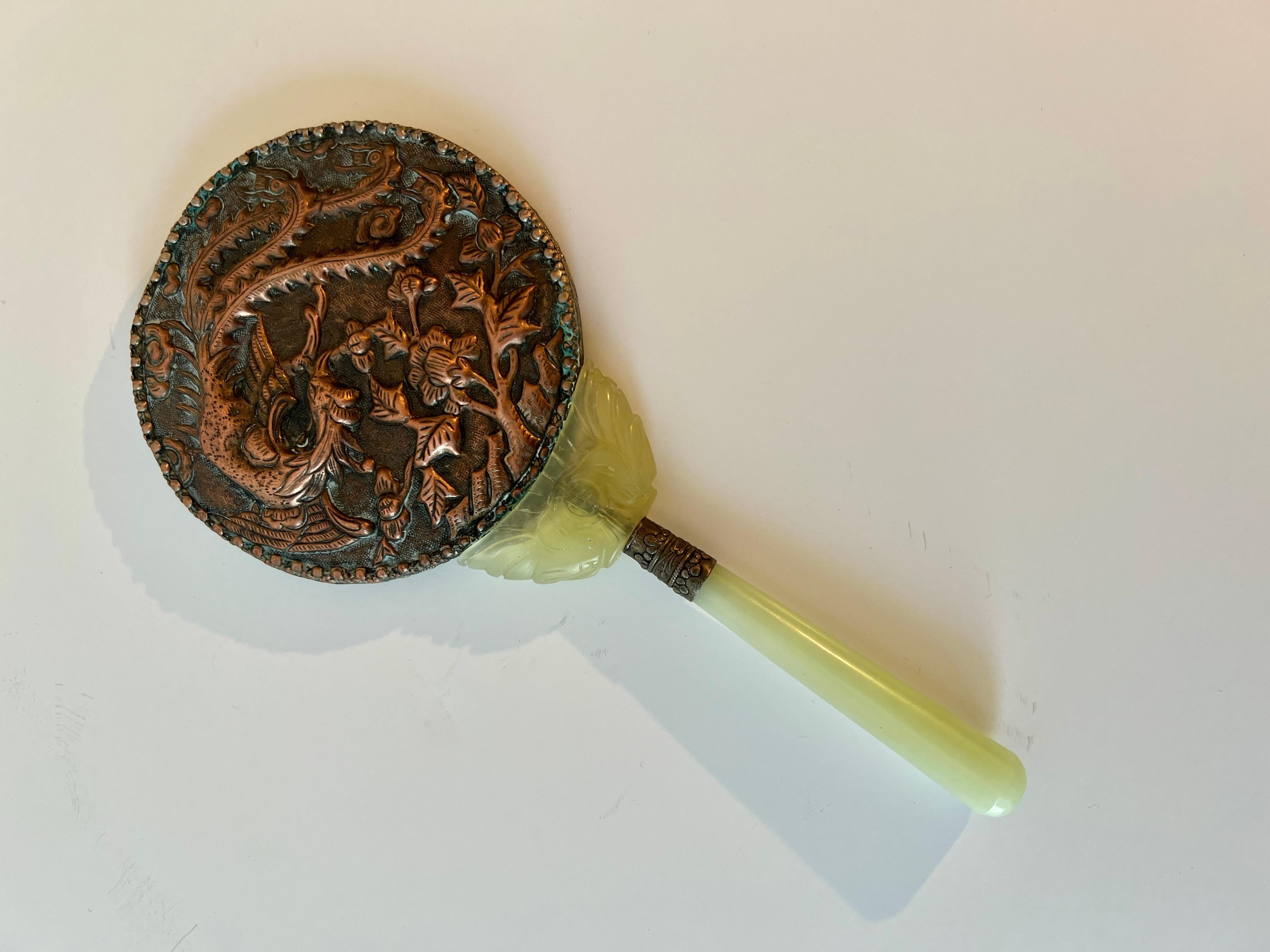 A beautiful hand mirror with repousse Dragon and scene.   Filagree surround cradled by jade and Celadon Handle.

A wonderful decorative piece and certainly great for practical use for those periodical quick checks.

A lovely wedding gift, birthday