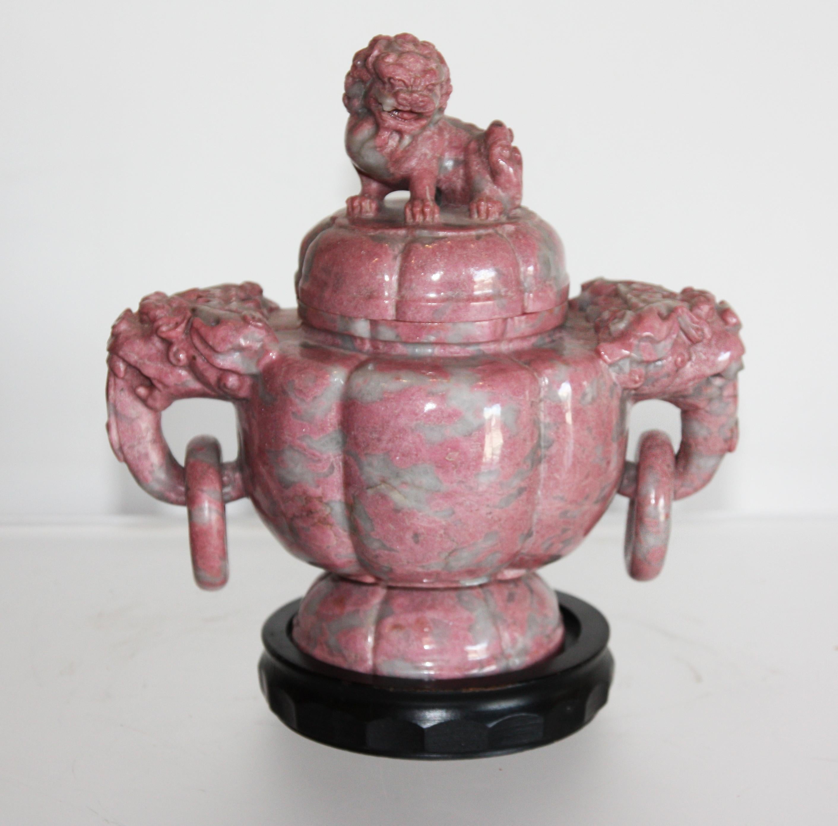 Three Chinese, hand-carved, pink, lidded marble urns with plinths. Foo dog, Lion, and elephant figured on each urn.

Dimensions given are for the large rectangular urn. 

Dimensions for small round urn depth 5.5 inches, width 8.5 inches, height