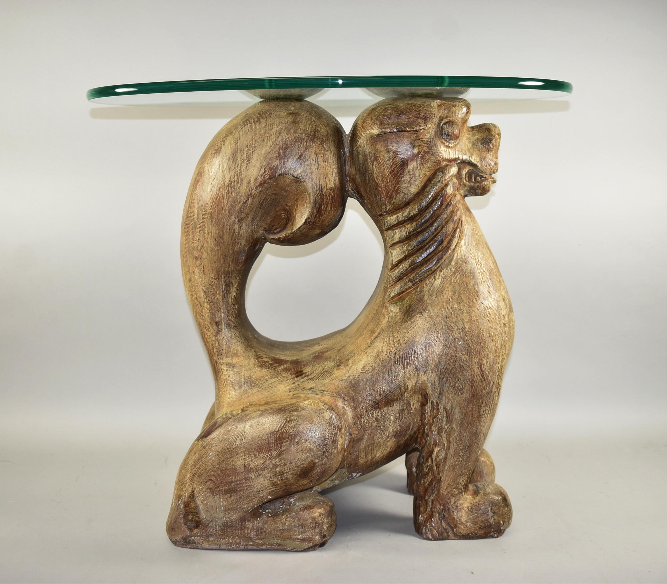 Solid wood carved Chinese Foo dog side table. Two brass plates hold an oval glass top. Some cracks and paint loss as shown in photos. Dimensions: 14.5