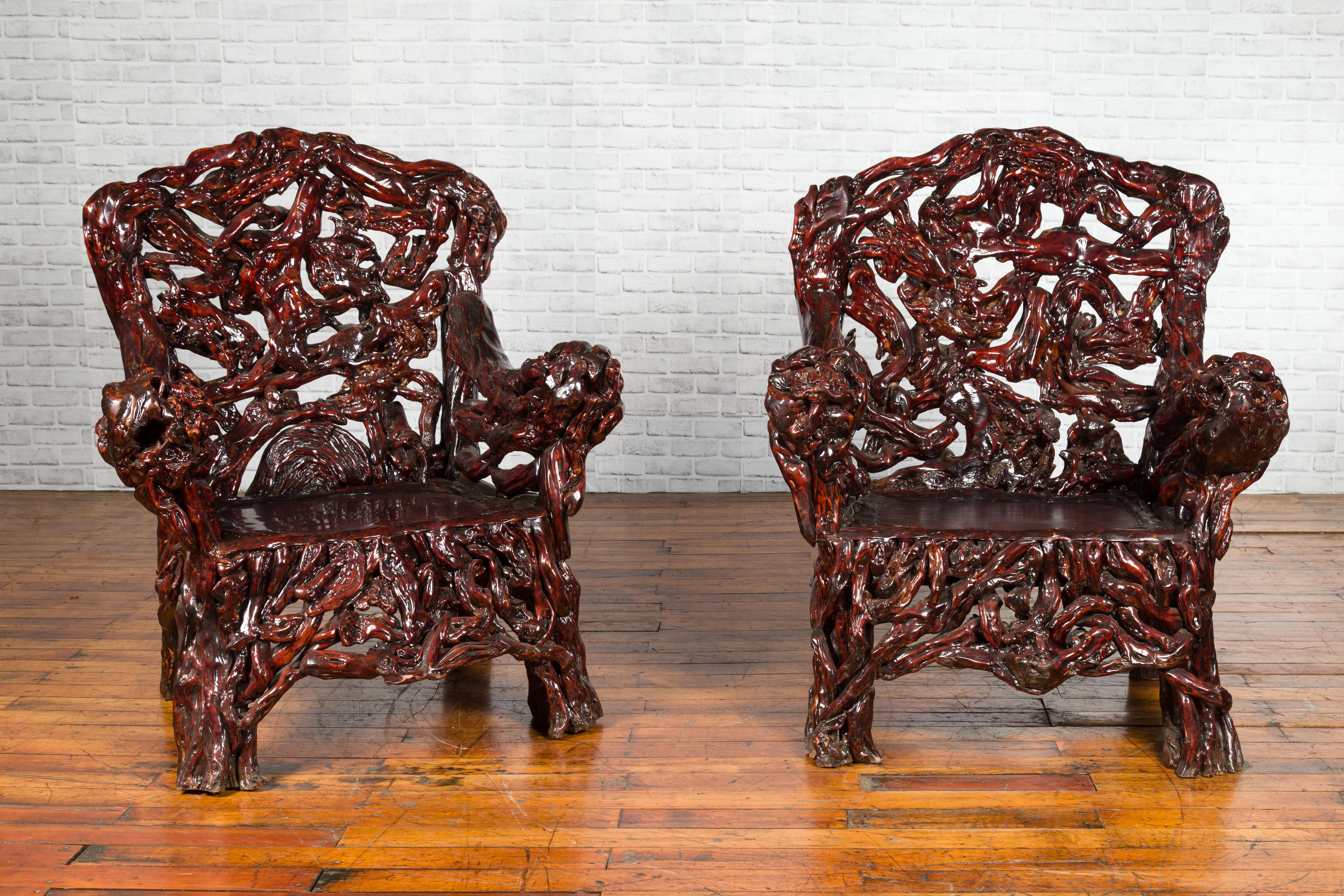 A pair of Chinese hand carved azalea wood root armchair from the late 20th century, priced and sold individually $5,500 each. Created in China during the later years of the 20th century, chair was handcrafted from an actual azalea tree, giving them
