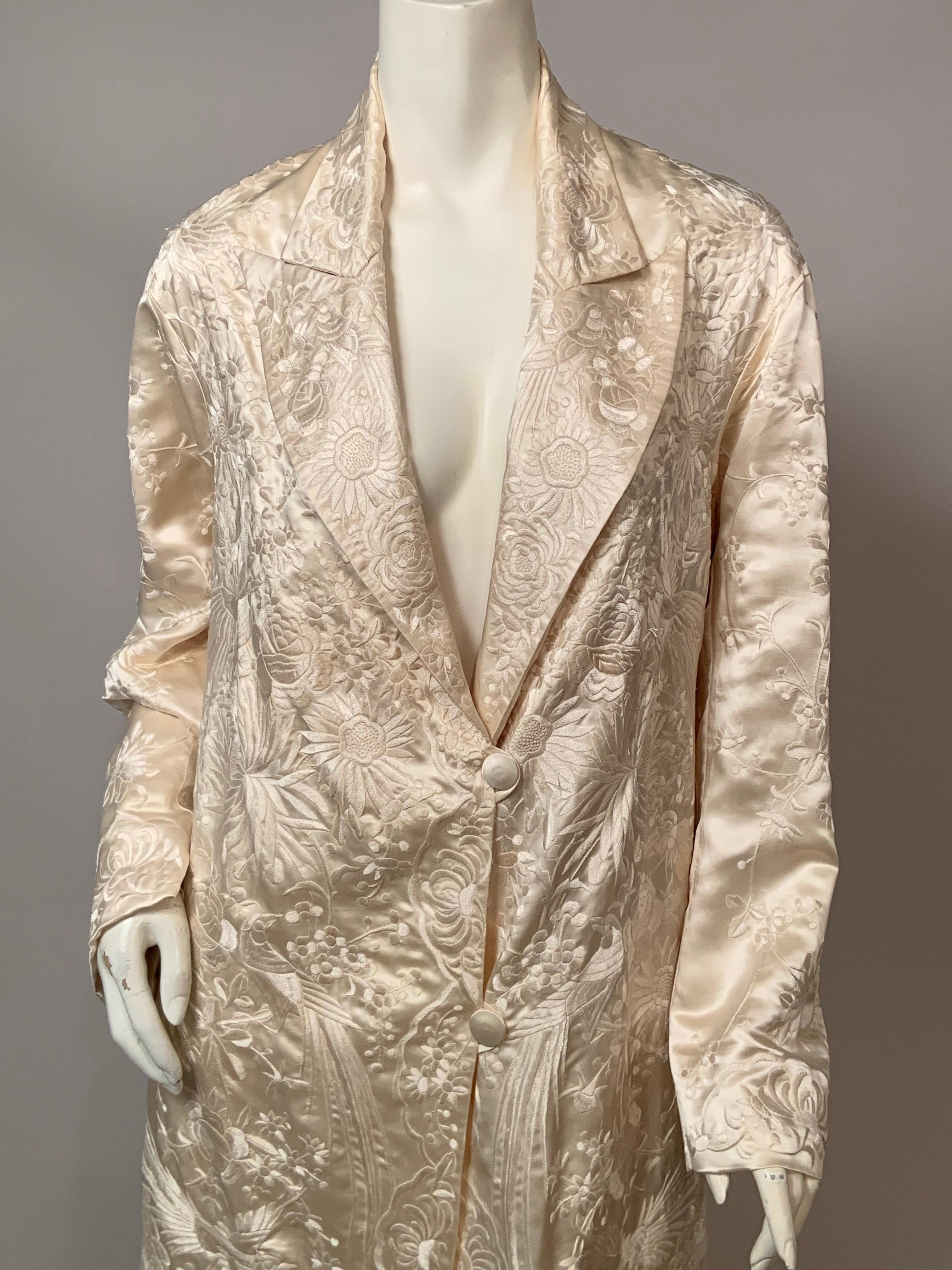 This Chinese cream on cream silk hand embroidered coat is absolutely stunning and is worked with cream silk thread on a cream silk background. There are chrysanthemums, daisies, roses and floral vines in addition to butterflies and elegant birds