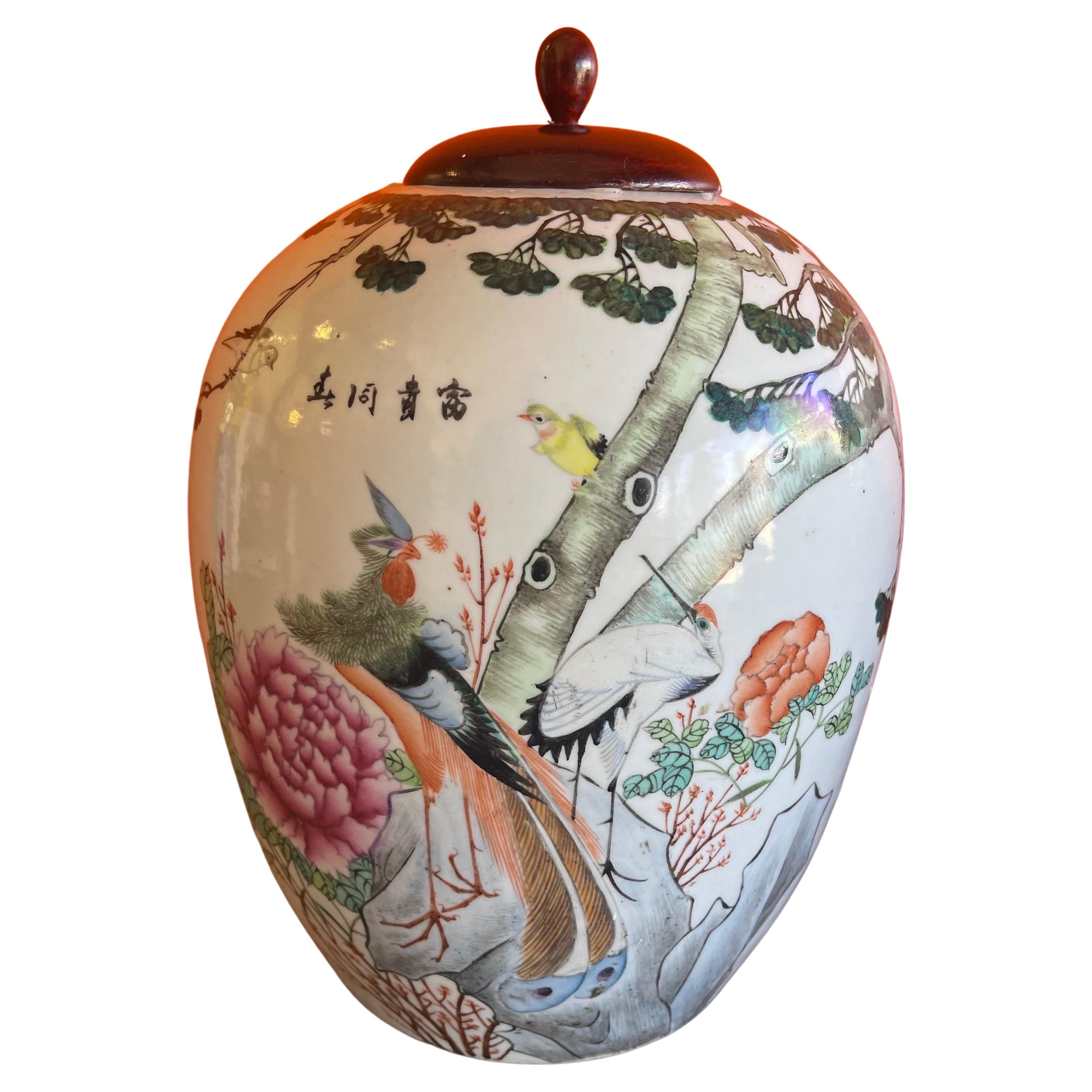 Beautiful ceramic hand painted Chinese ginger jar with wood lid from the Republic period, circa 1920s. The jar is in very good condition with no chips or cracks and measure 9.5