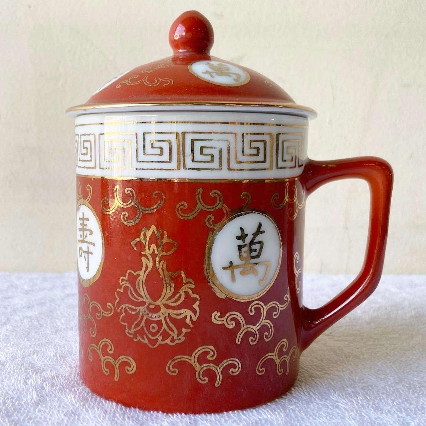 Wonderful vintage Chinese porcelain tea cup with lid. Features a hand painted red and gold design.
