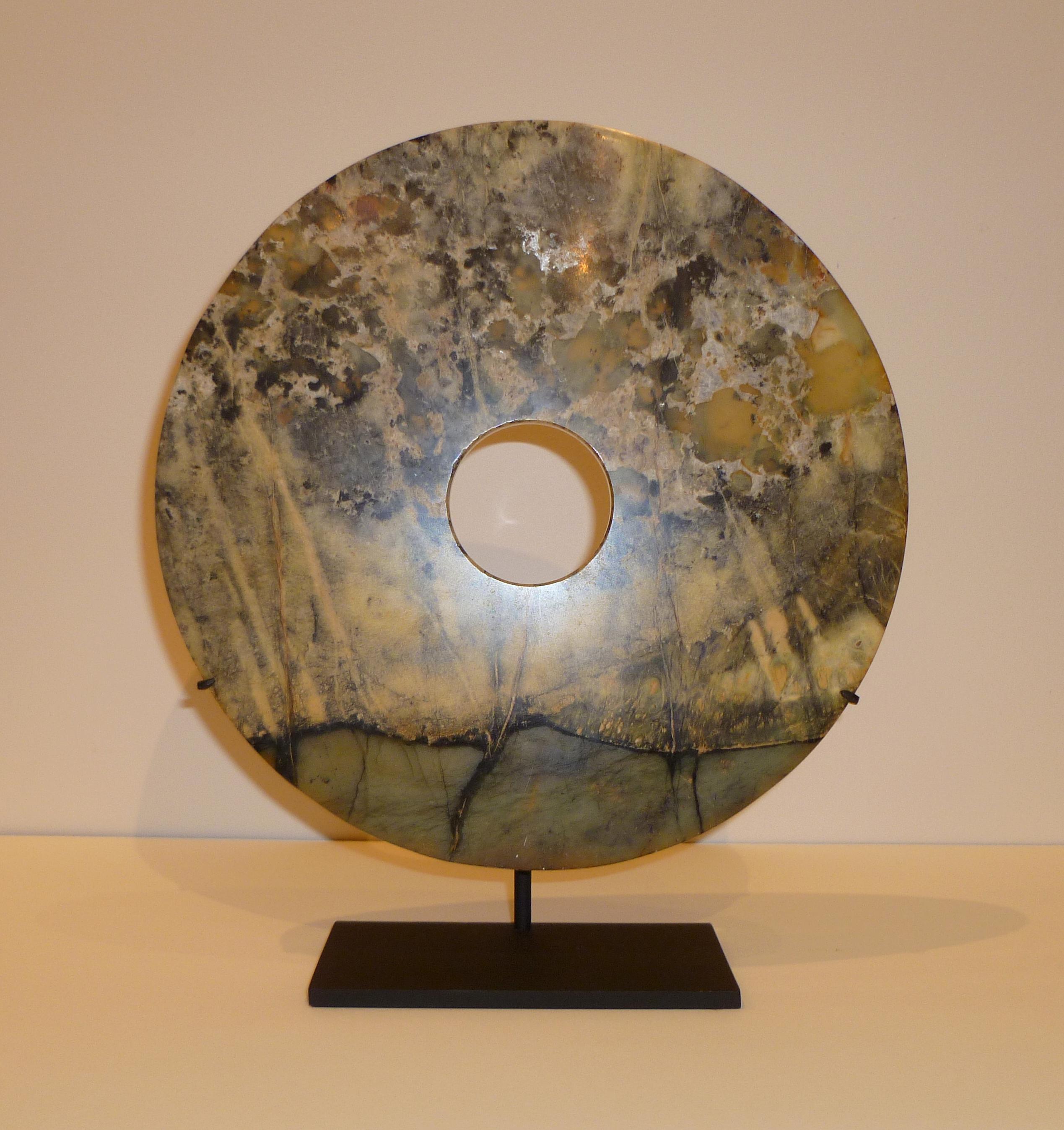 Fine Chinese hard stone disc on black metal stand, beautiful form, color and texture. 10
