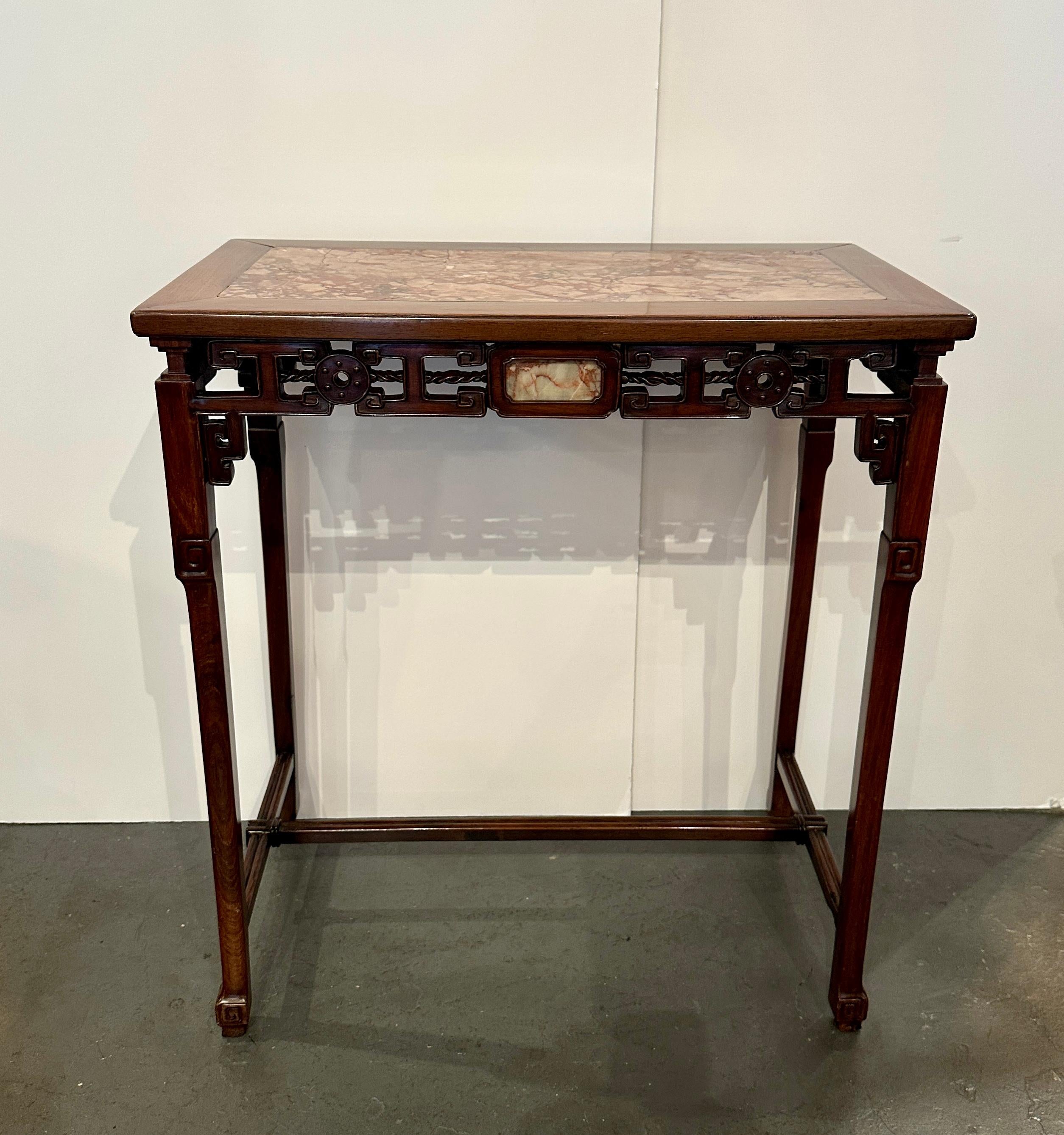 An elegant, hand-carved, hardwood table with inset marble top and panels on all 4 sides.  Featuring open wood work apron and stretcher.