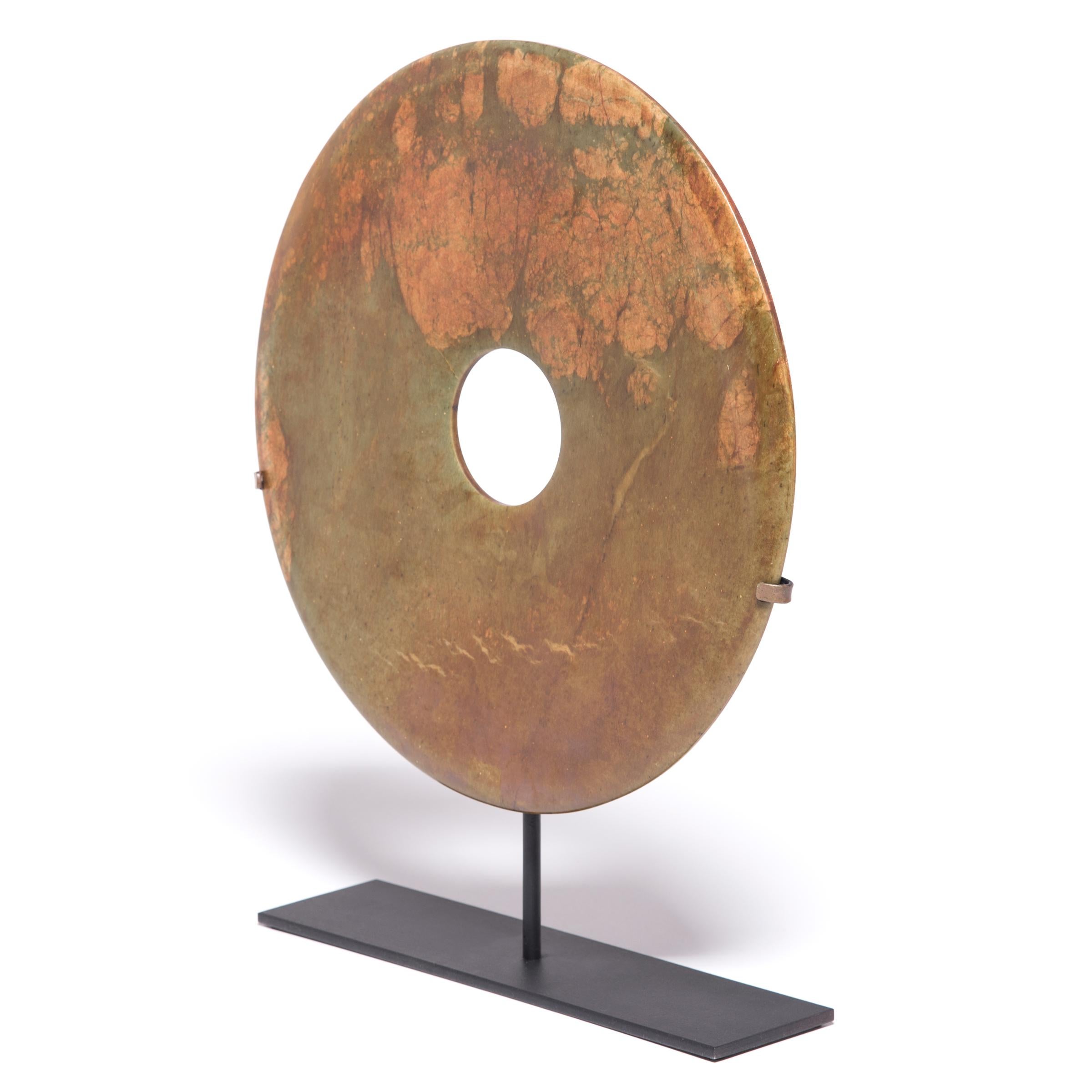 Found in the tombs of ancient Chinese emperors and aristocrats, bi discs such as this have a mysterious and spiritual history, and their function and significance remain unknown. Shaping this hard stone takes considerable skill. An artisan imbues