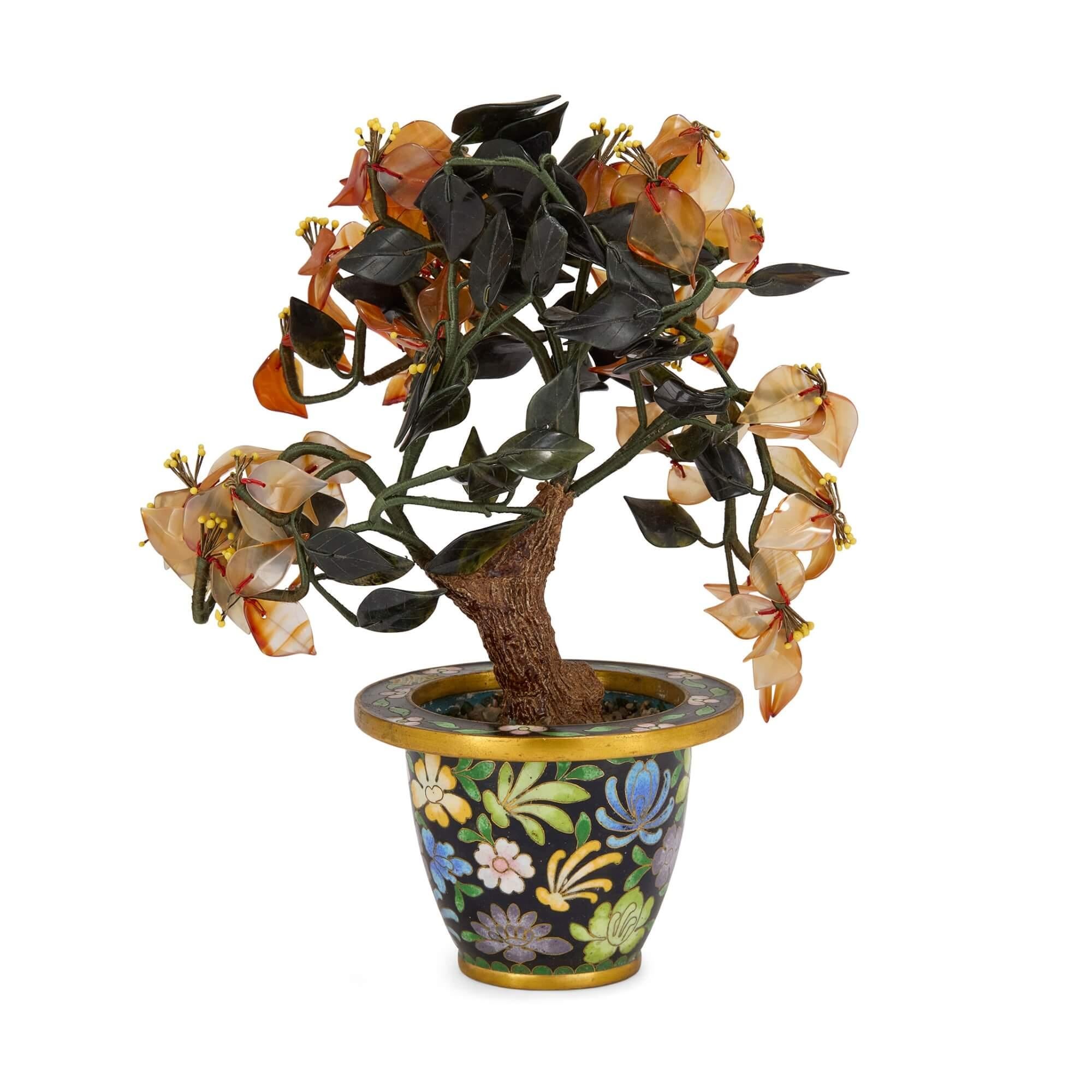 Chinese hardstone flower model in a cloisonné enamel pot
Chinese, 20th Century
Height 20cm, width 16cm, depth 9cm 

Crafted in 20th century China, this charming flower model is crafted from various materials such as carnelian, jade, and cloisonné