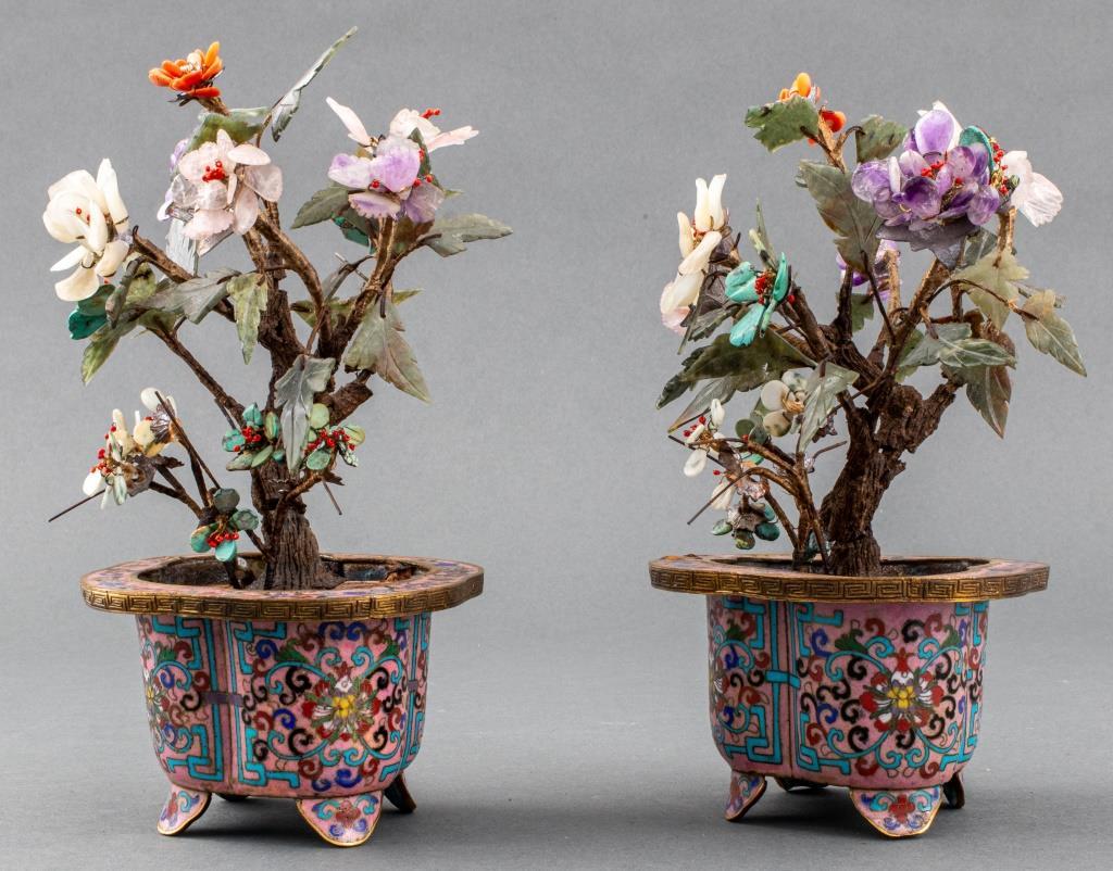 Pair of Chinese hardstone tree sculptures comprised of amethyst, rock crystal, greenstone, turquoise, and coral, housed in cloisonne jardinieres with scrolling foliate motifs on rose pink grounds upon four flaring feet, each marked 