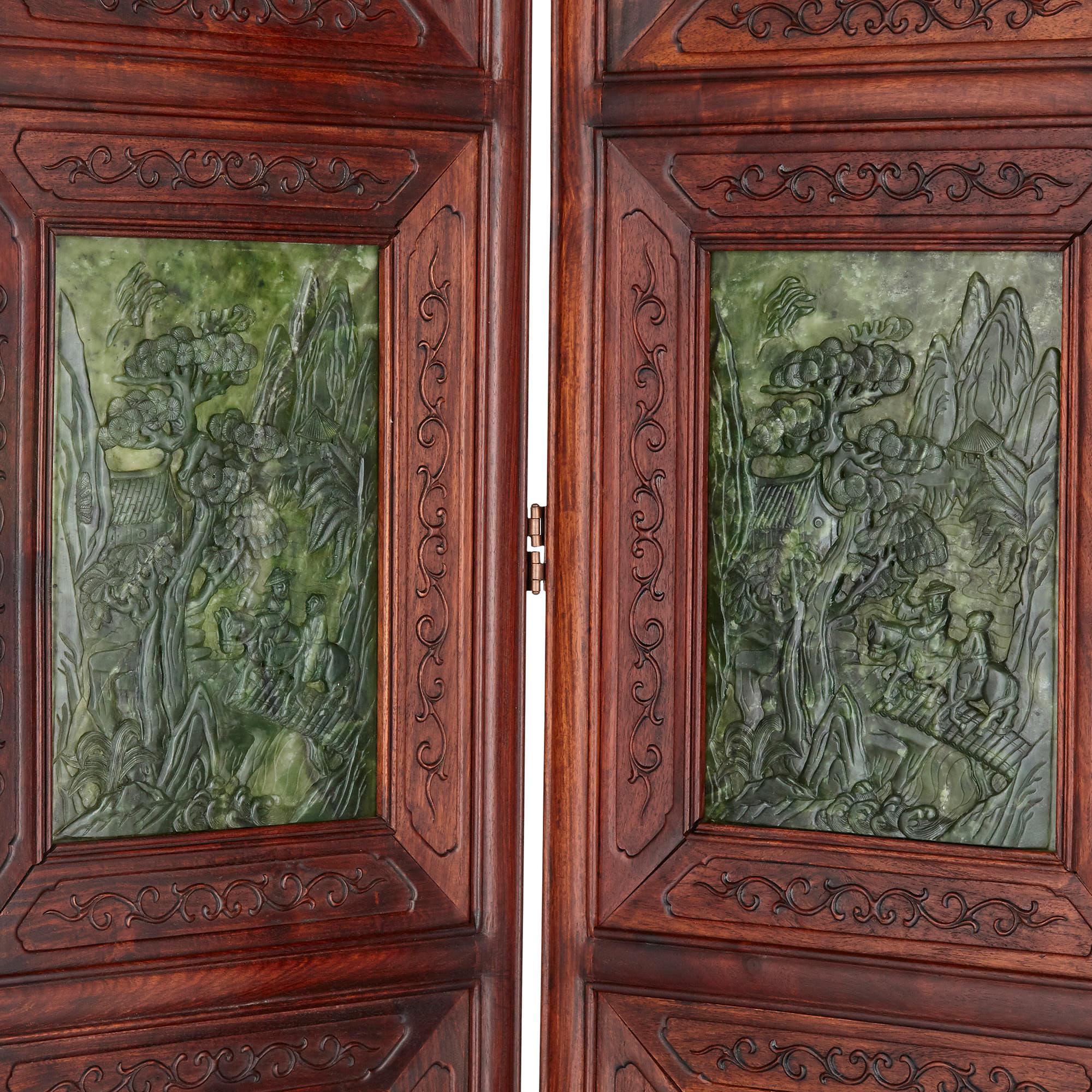 This screen, comprised of four sections and formed from Chinese hardwood and nephrite, is a beautiful piece of Chinese design—the dark lustre of the nephrite accenting the warm tones of the hardwood. Each wooden section of the screen, carved with