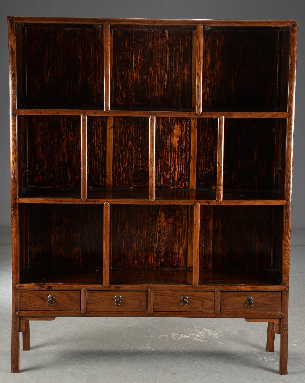 Chinese display cabinet or bookcase of stained hardwood, with compartments and drawers.