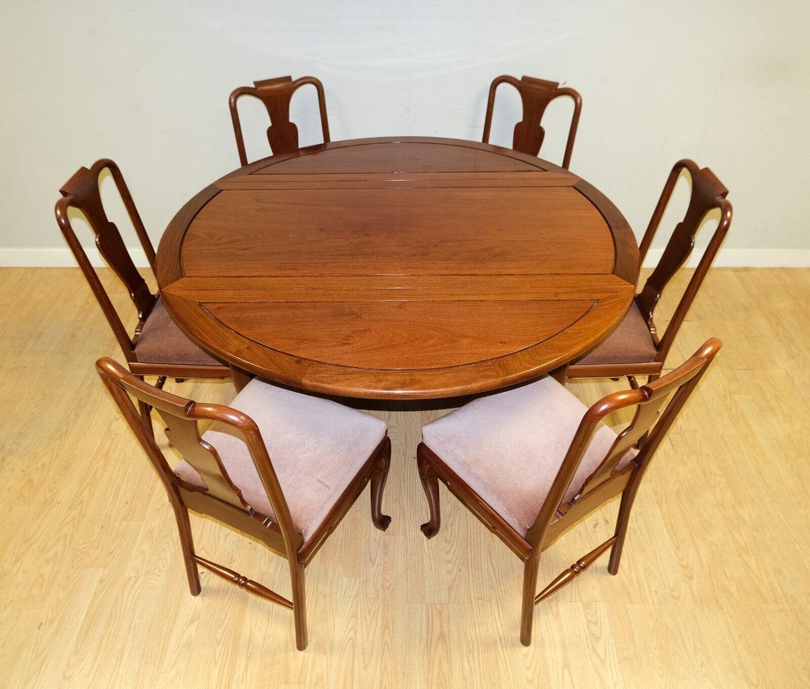 We are delighted to offer for sale this stunning Chinese Rosewood drop leaf dining table on claw and ball feet and eight chairs. 

This well made and good looking set comes with eight chairs on velvet seat covers and a drop leaf table on claw and