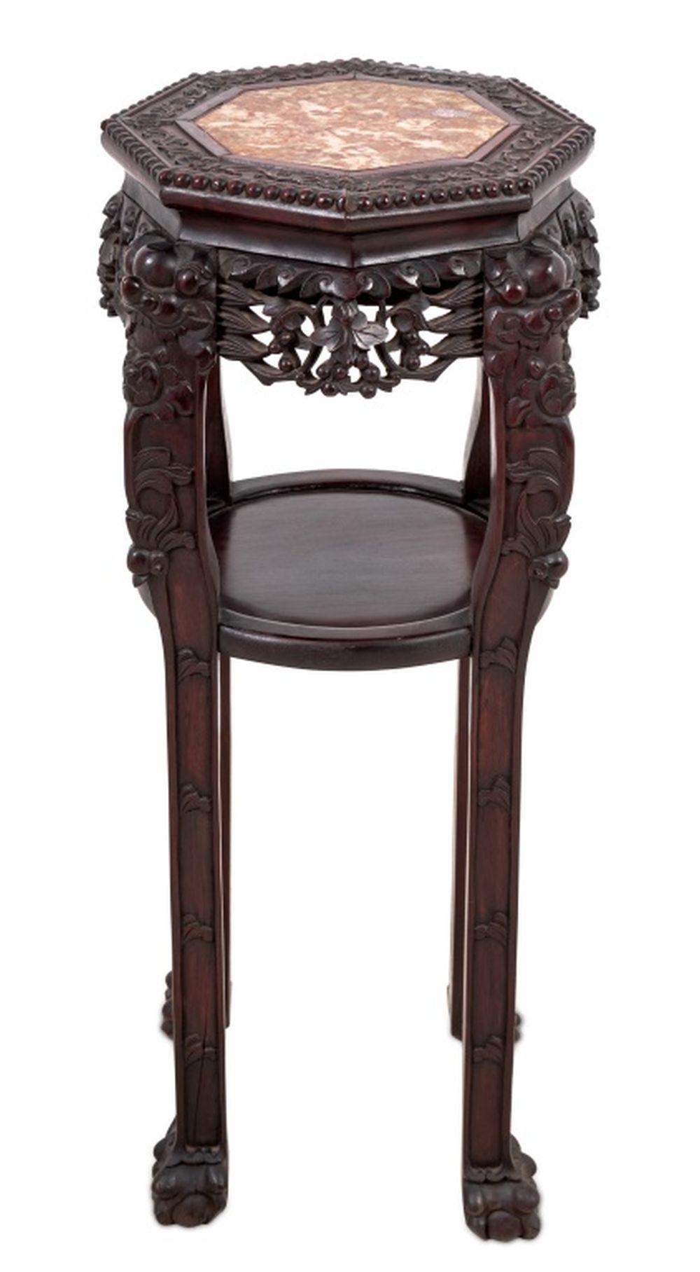 Chinese Carved Hardwood and Marble Two Tier Pedestal Table, late 19th century, the octagonal top above tall legs with ball and claw feet.

33.5