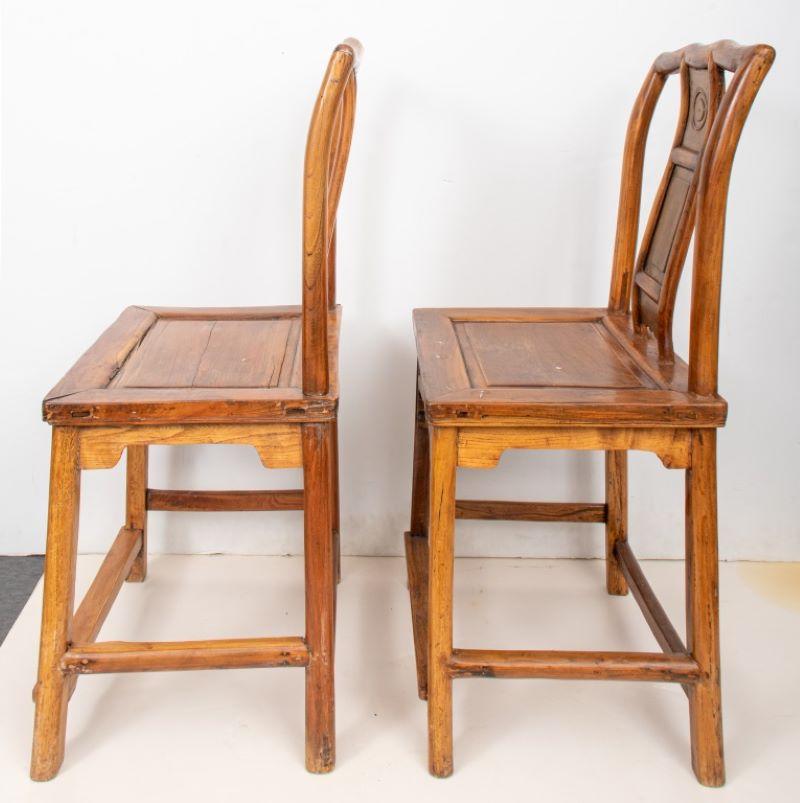 Pair of Chinese hardwood side chairs with geometric details, probably late 19th / early 20th century. 36