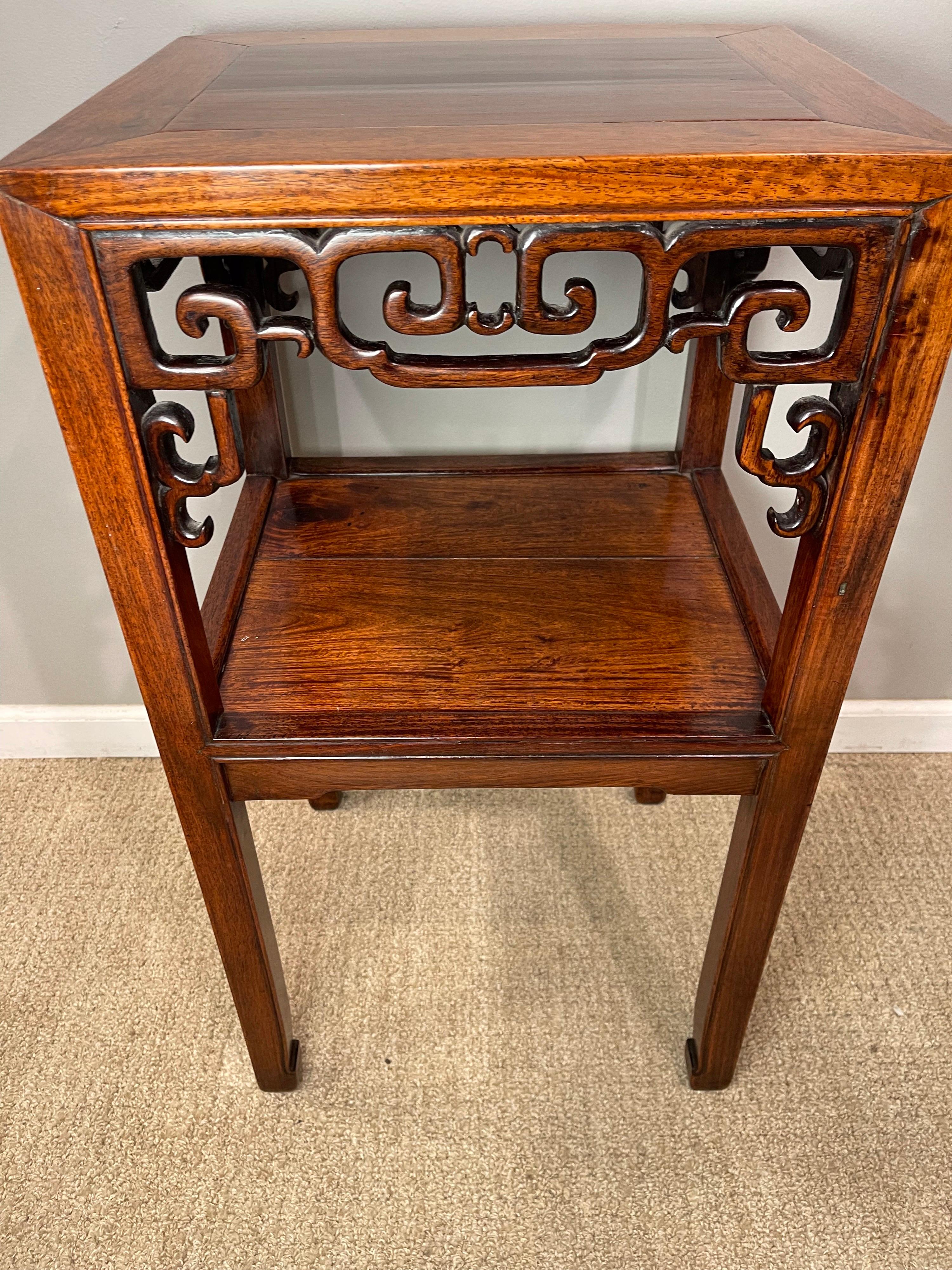 Chinese Hardwood (Hungmu) Tea Table, Late 19th Century / Early 20th Century 
Having exceptional color 
It's Top above with carved scrolled brackets below & lower shelf.

 