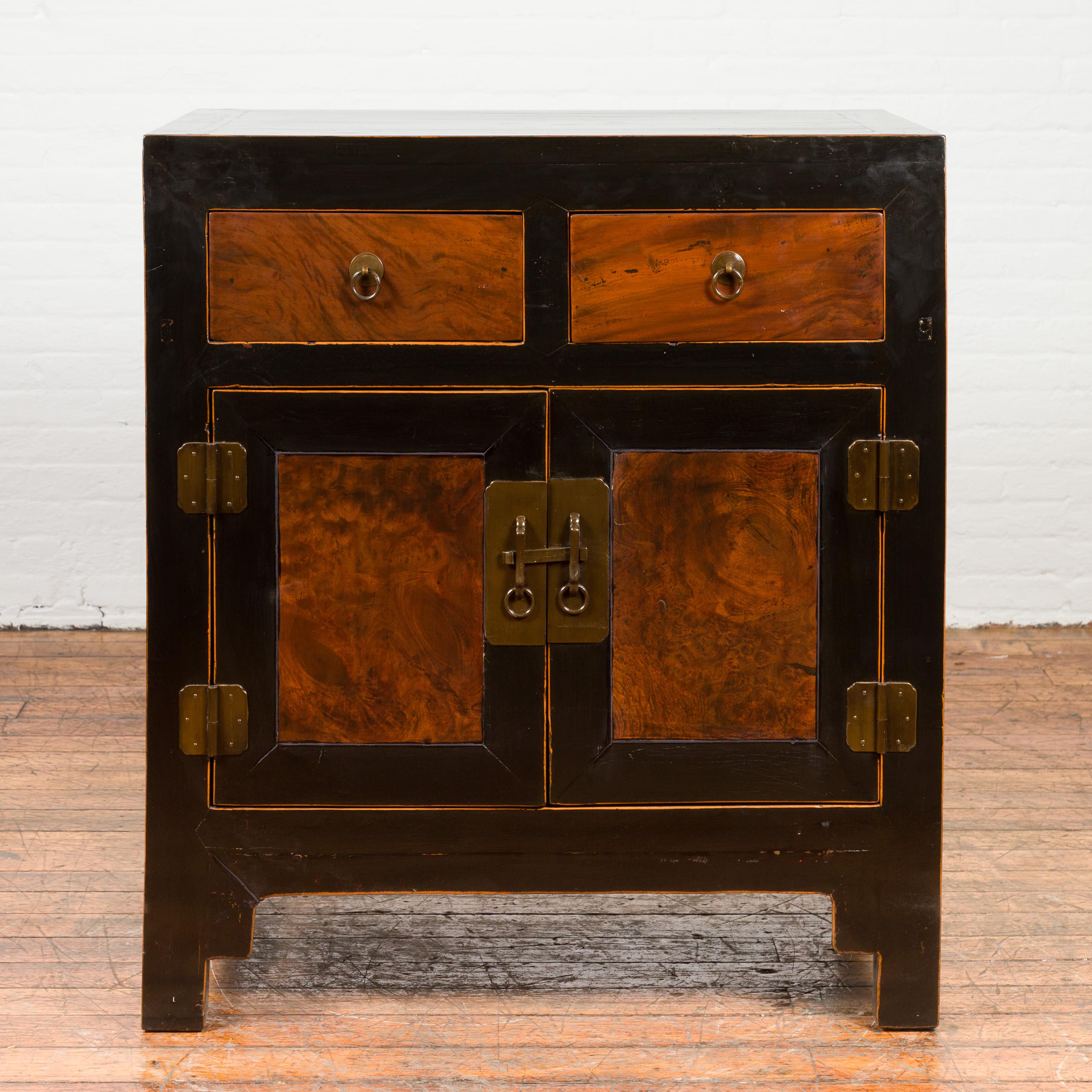 A Chinese Hebei black lacquer low cabinet from the early 20th century, with burl wood doors and drawers. Created in the Northeastern province of Hebei during the early years of the 20th century, this low cabinet features a linear silhouette