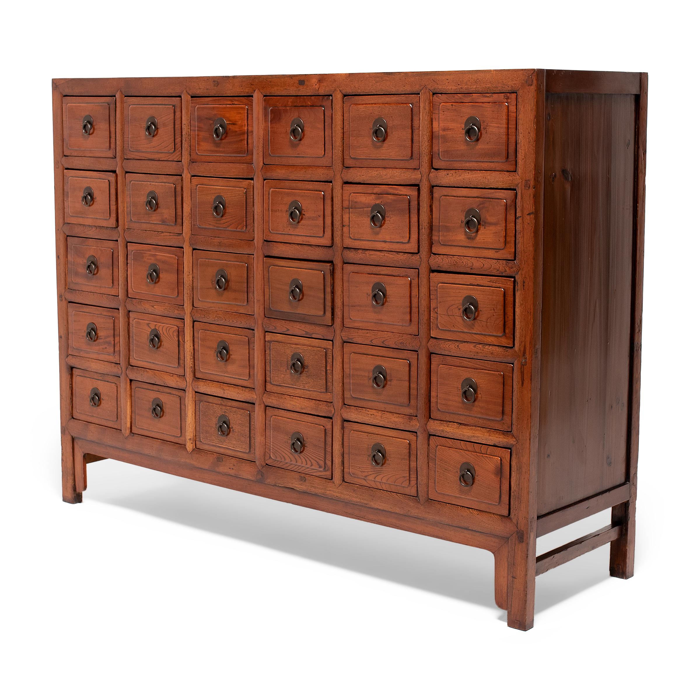 This gorgeous late 19th-century apothecary chest was originally used by a Chinese pharmacy to organize and store herbal medicines. A statement piece brilliantly constructed with mortise and tenon joinery, it has thirty drawers, each fitted with two