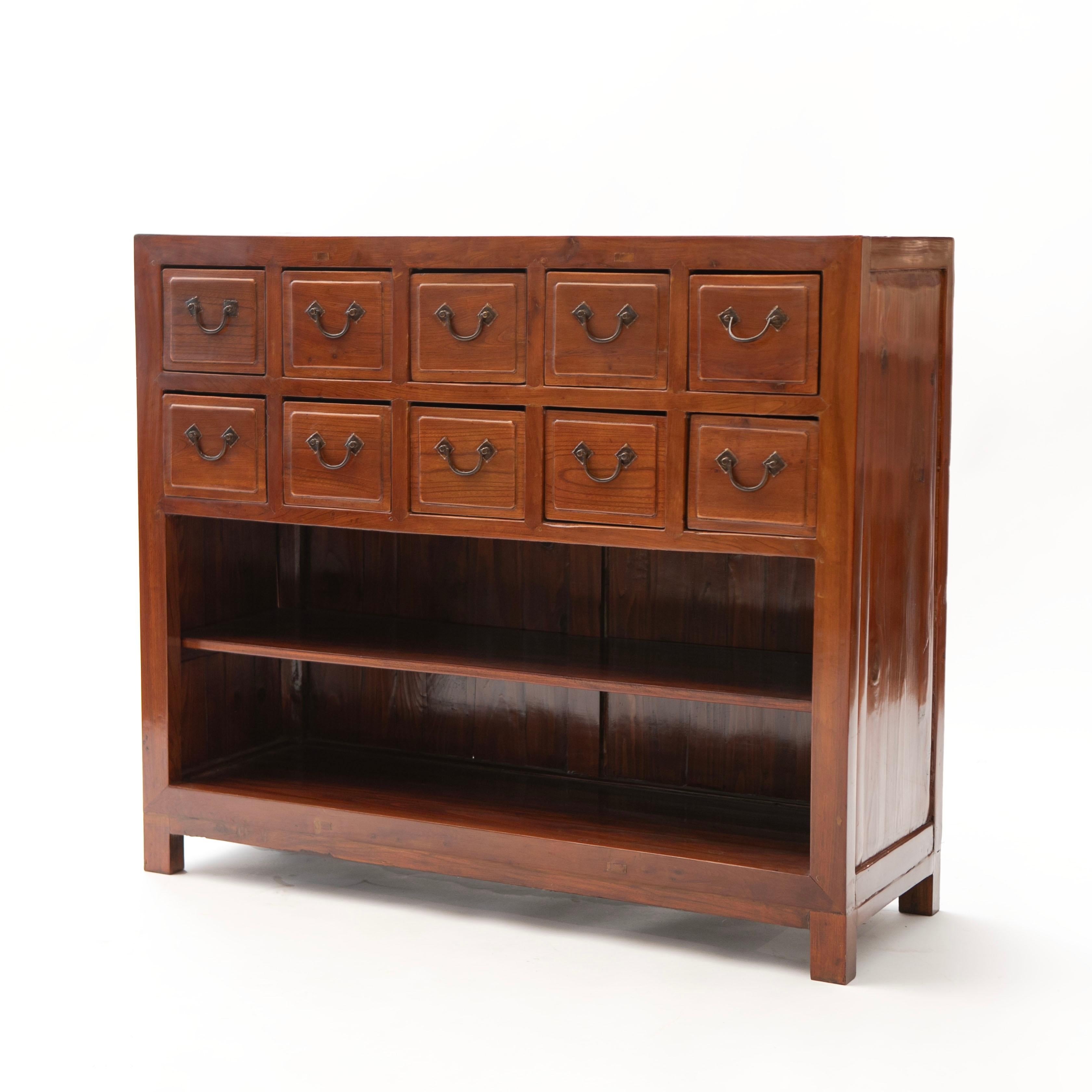 A Chinese Qing Dynasty period late 19th century apothecary merchant's chest in Southern elm, also called Jumu wood.
Originally used by a Chinese pharmacy to organize and store herbal medicines.
This chest features 10 drawers (2x5) in the upper