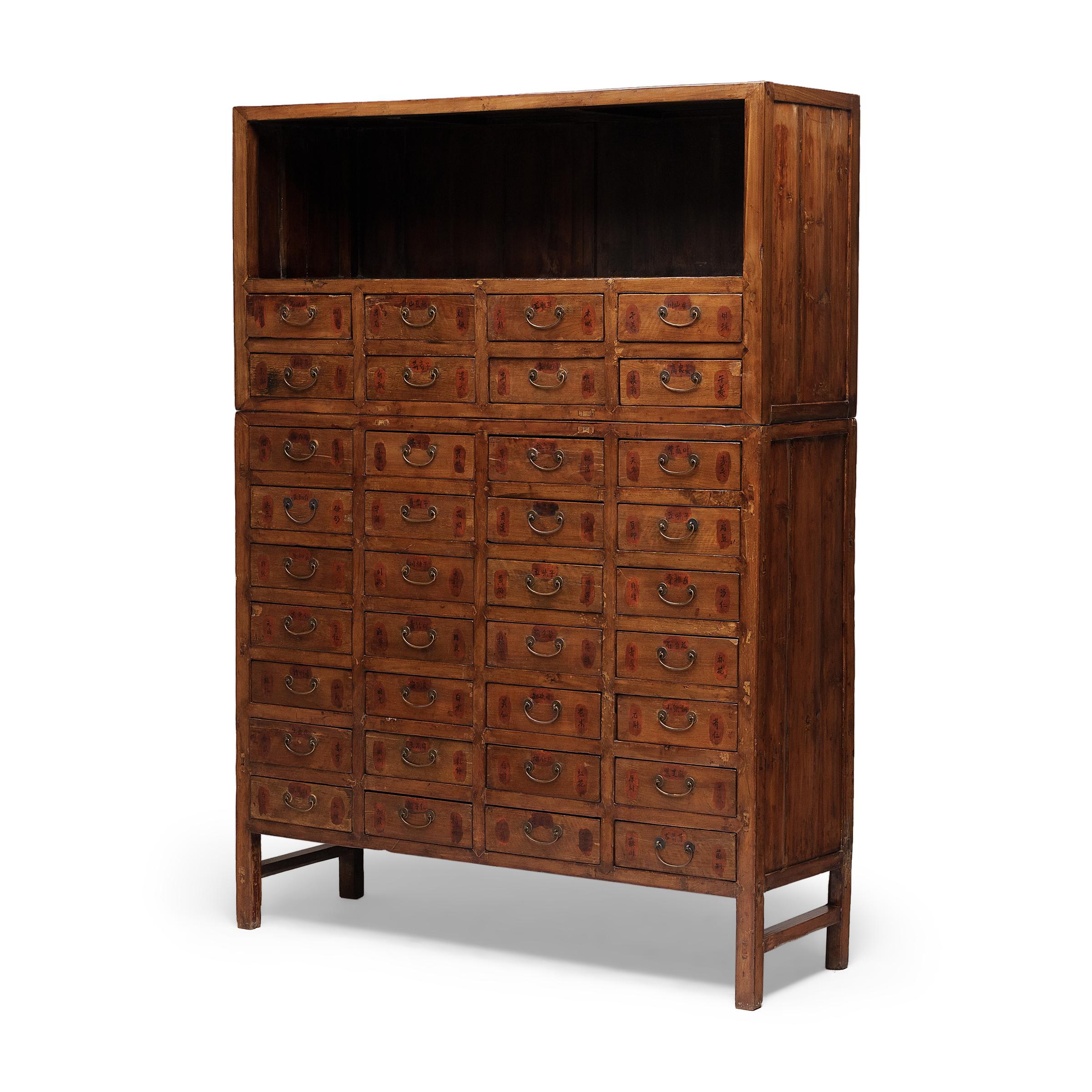 This many-drawered cabinet is a 19th-century Chinese apothecary chest, originally used in a pharmacy to organize and store traditional herbal medicines. A statement piece brilliantly constructed with mortise and tenon joinery, the cabinet has a