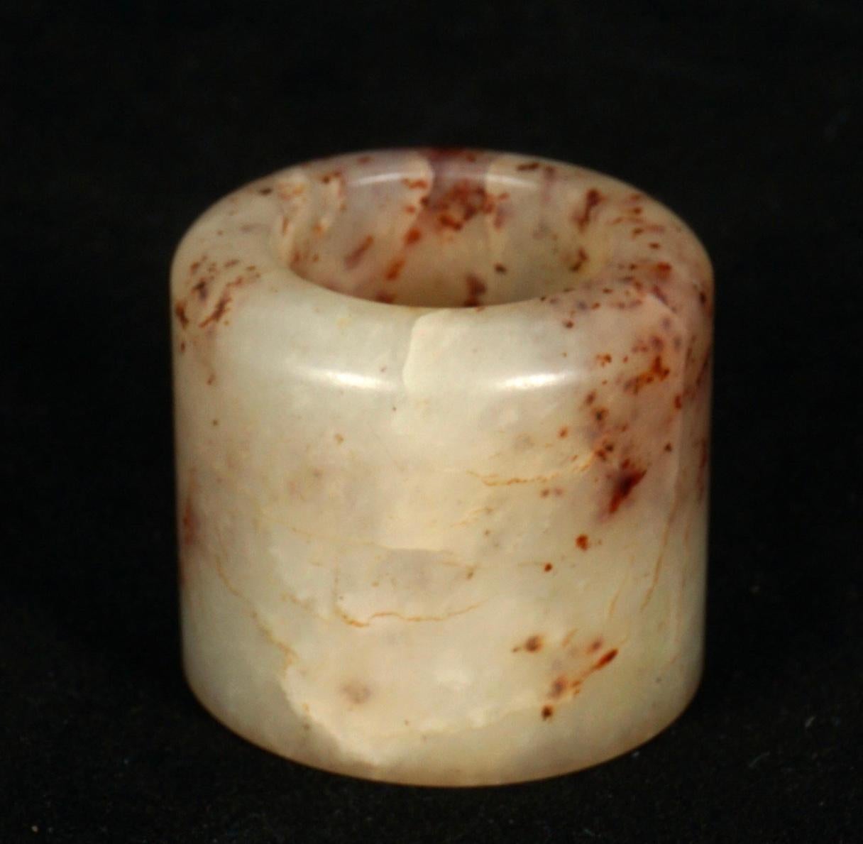 Nicely colored jade Chinese archer ring that feel oh-so-soft, heavy and cold to the touch. Jade archer rings with very soft hand polished finish that is carved from a pale brown jade with darker inclusions and matrix. Well rounded edges with carved