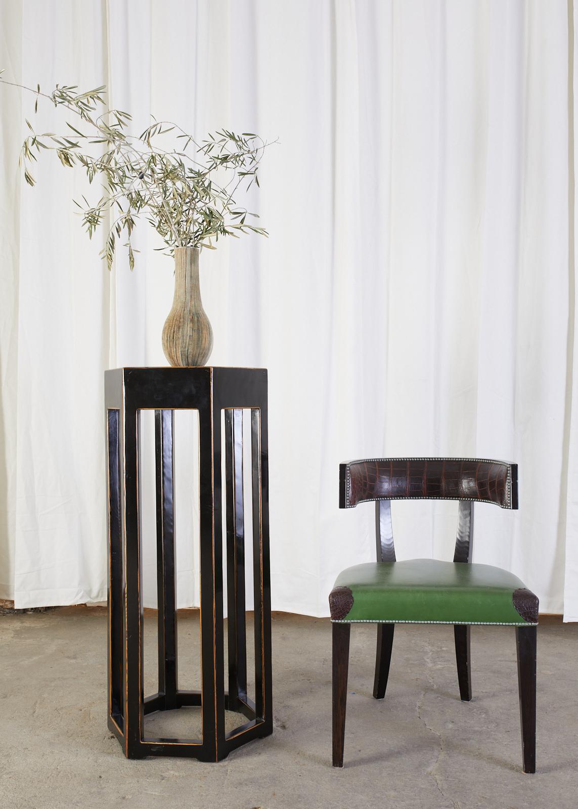 Distinctive Chinese export hardwood pedestal table or plant stand featuring a molded stone top. The hardwood frame has a lacquered black finish with an intentionally aged patina. The top of the table is inset with an interesting molded stone with a