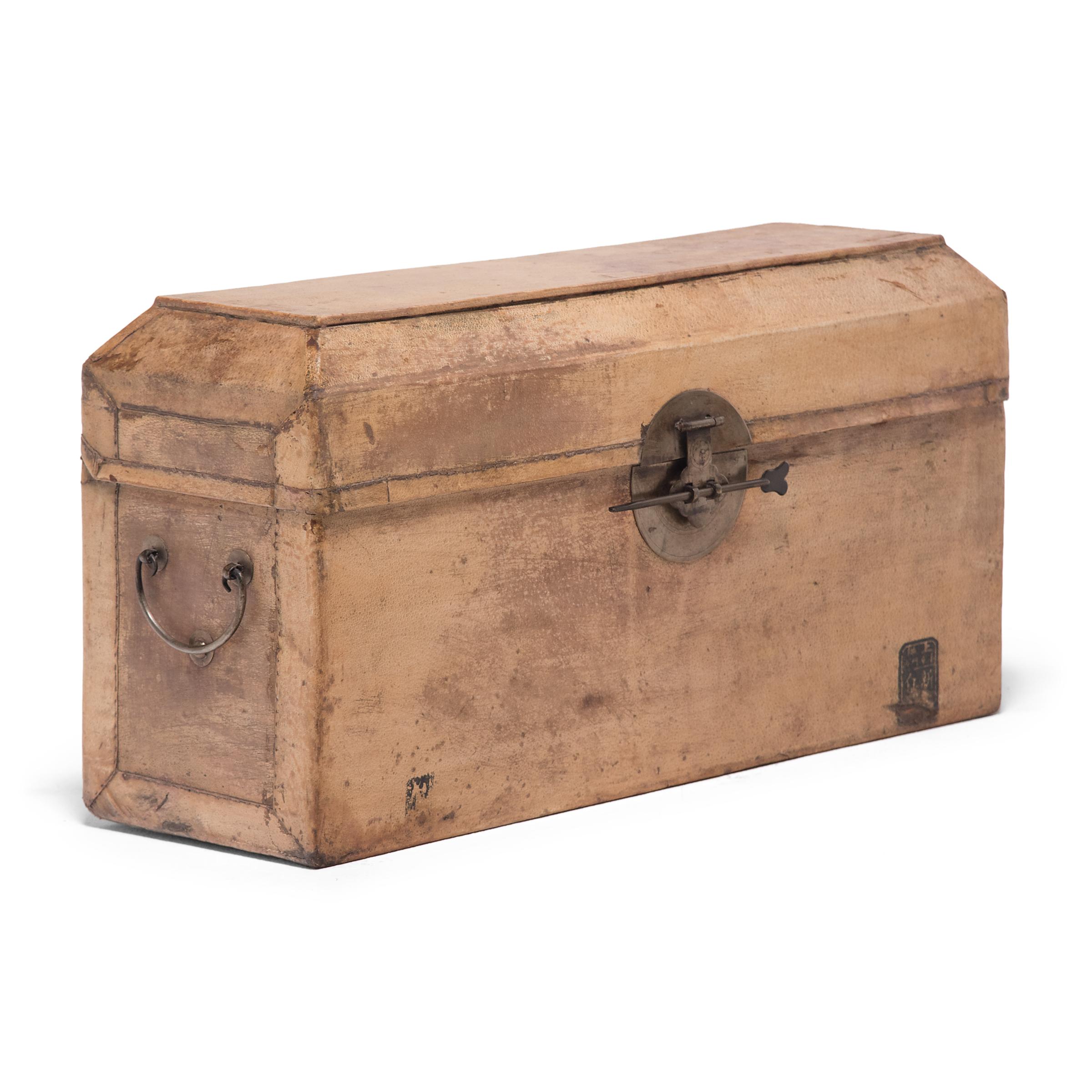 This gorgeous document box once sat in the studio of a Qing-dynasty scholar-official, used to store and protect his works of fine calligraphy and landscape painting. The box is minimally decorated, wrapped in a layer of light brown pig's hide with
