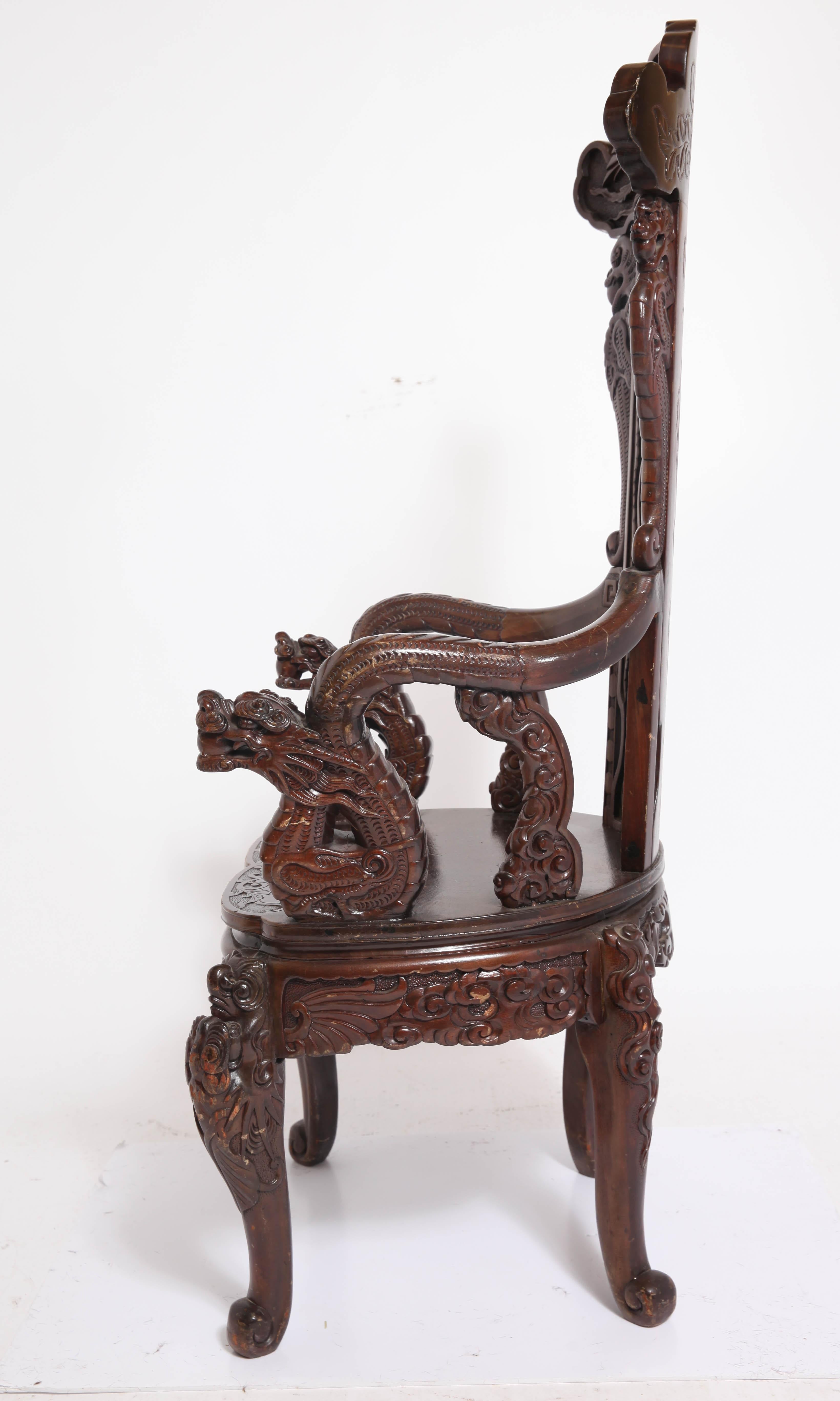 Art Nouveau style Japanese-export high-back armchair with highly detailed carved wood dragon and phoenix theme. The chair is in great vintage condition with some minor age-appropriate wear.