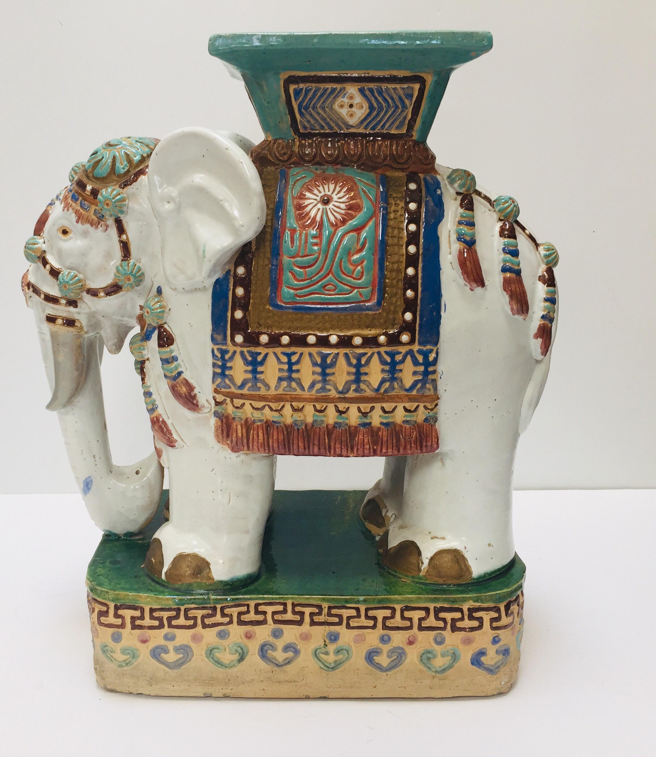 Large vintage midcentury Asian Chinese elephant garden patio stool.
Elegant garden seat in the shape of an elephant heavily decorated in oriental finery. 
The mammal seat on a raised pedestal and has a square seat at the top, it is hand painted in a