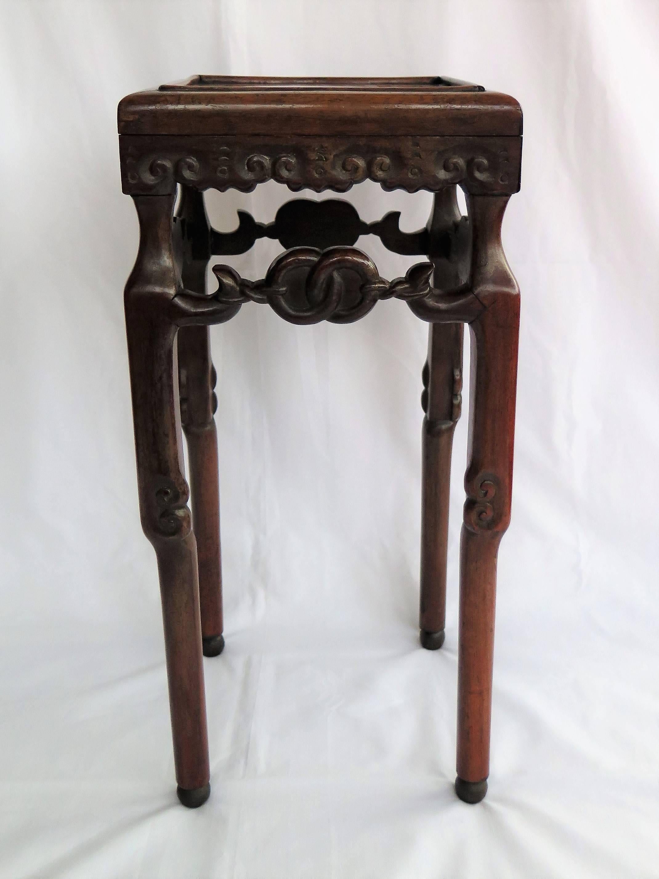 This is a crisply carved Chinese Hongmu hardwood stand or side table from the 19th century, Qing period.

The stand has a mitred inset figured square top, with a raised beeded surround, over a well carved freeze supported on four carved legs sat on