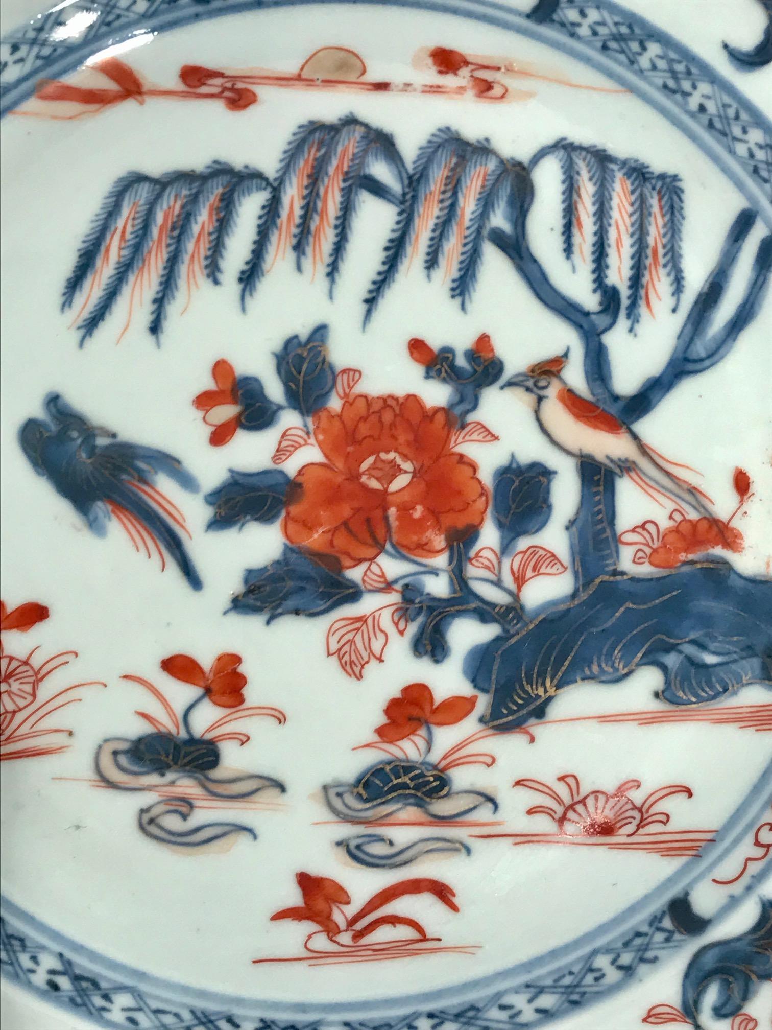 Antique Chinese export plate known as Chinese Imari from the Elinor Gordon Collection. Hand decorated first in an underglaze blue and then overpainted in iron red and gold. The center scene is of a tree surrounded by an outer border of scrolling