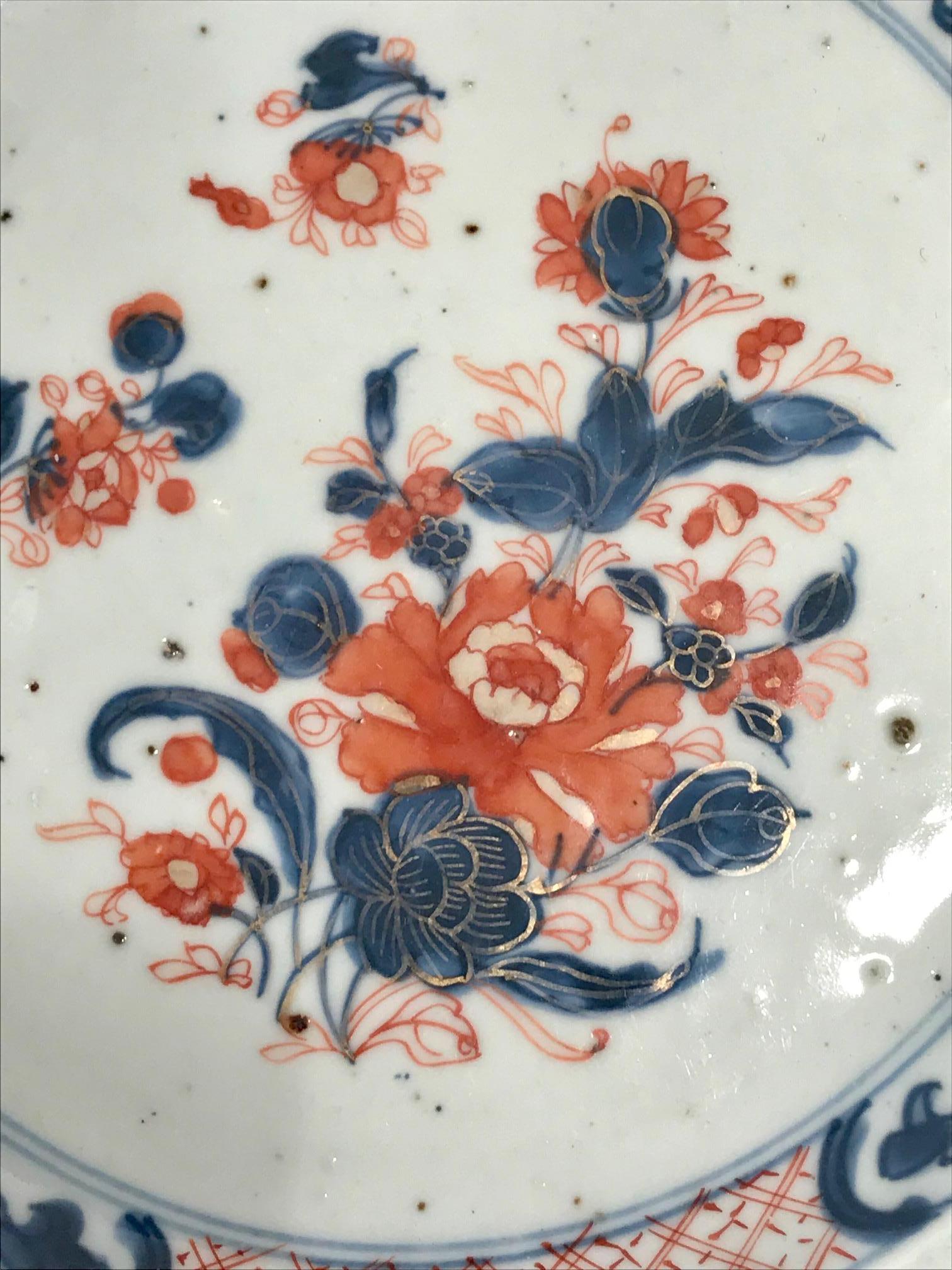 Antique Chinese Imari export porcelain plate from The Elinor Gordon Collection. Decorated by hand in an underglaze blue and then overpainted in iron red and gold and so it has become known as Chinese Imari. The center of the plate has a floral