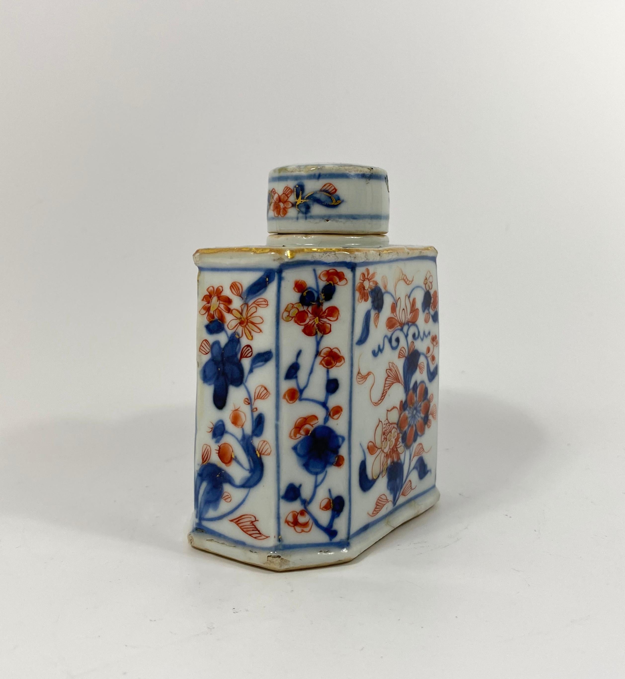 Chinese porcelain tea caddy and cover, circa 1700, Kangxi Period. The octagonal shaped caddy, painted to each panel, with flowering plants, in the Chinese Imari style. 
The circular cover, similarly decorated.
Having an unglazed